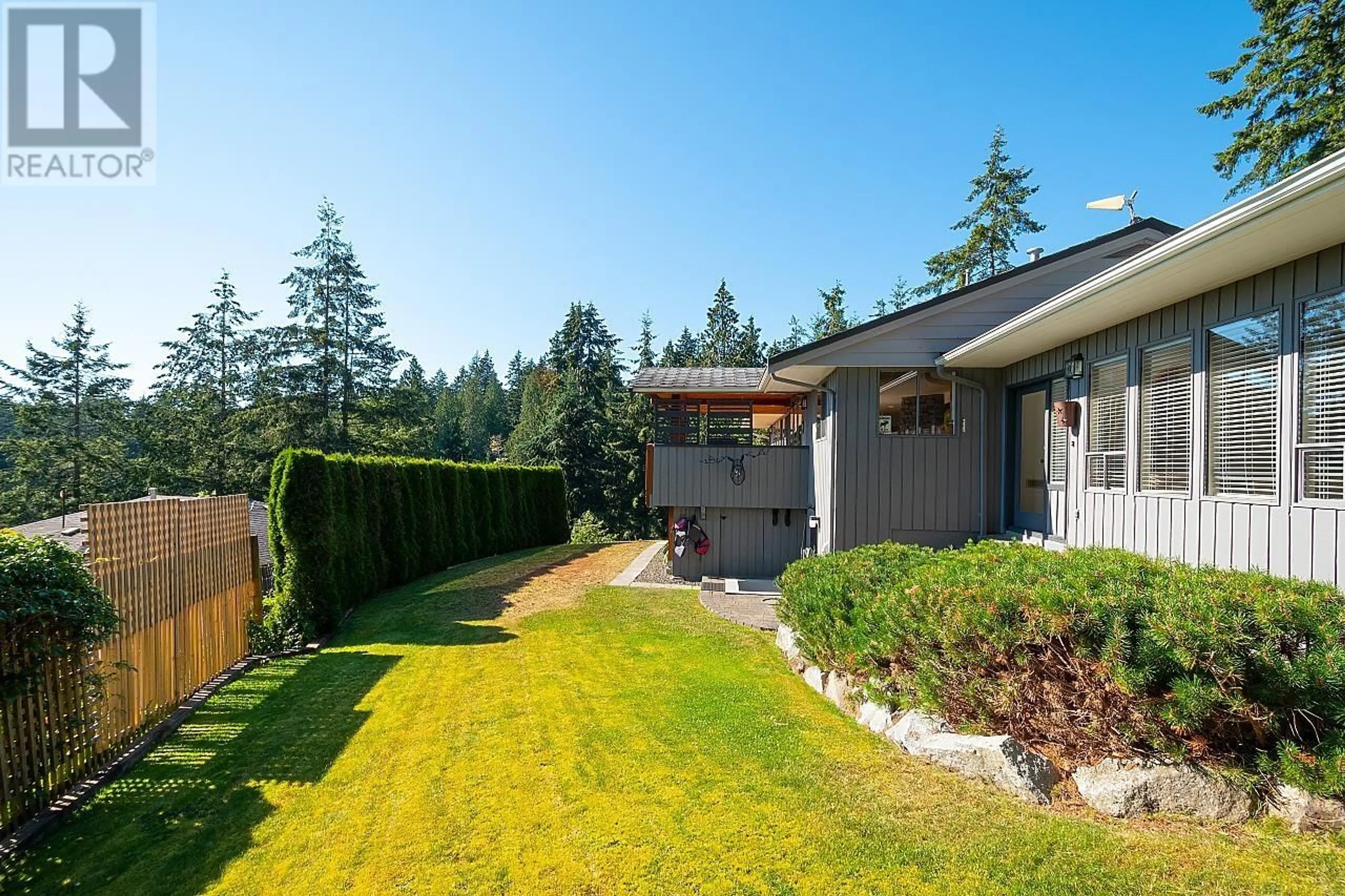 Frontside or backside of a home, the fenced backyard for 1526 WHITESAILS DRIVE, Bowen Island British Columbia V0N1G2