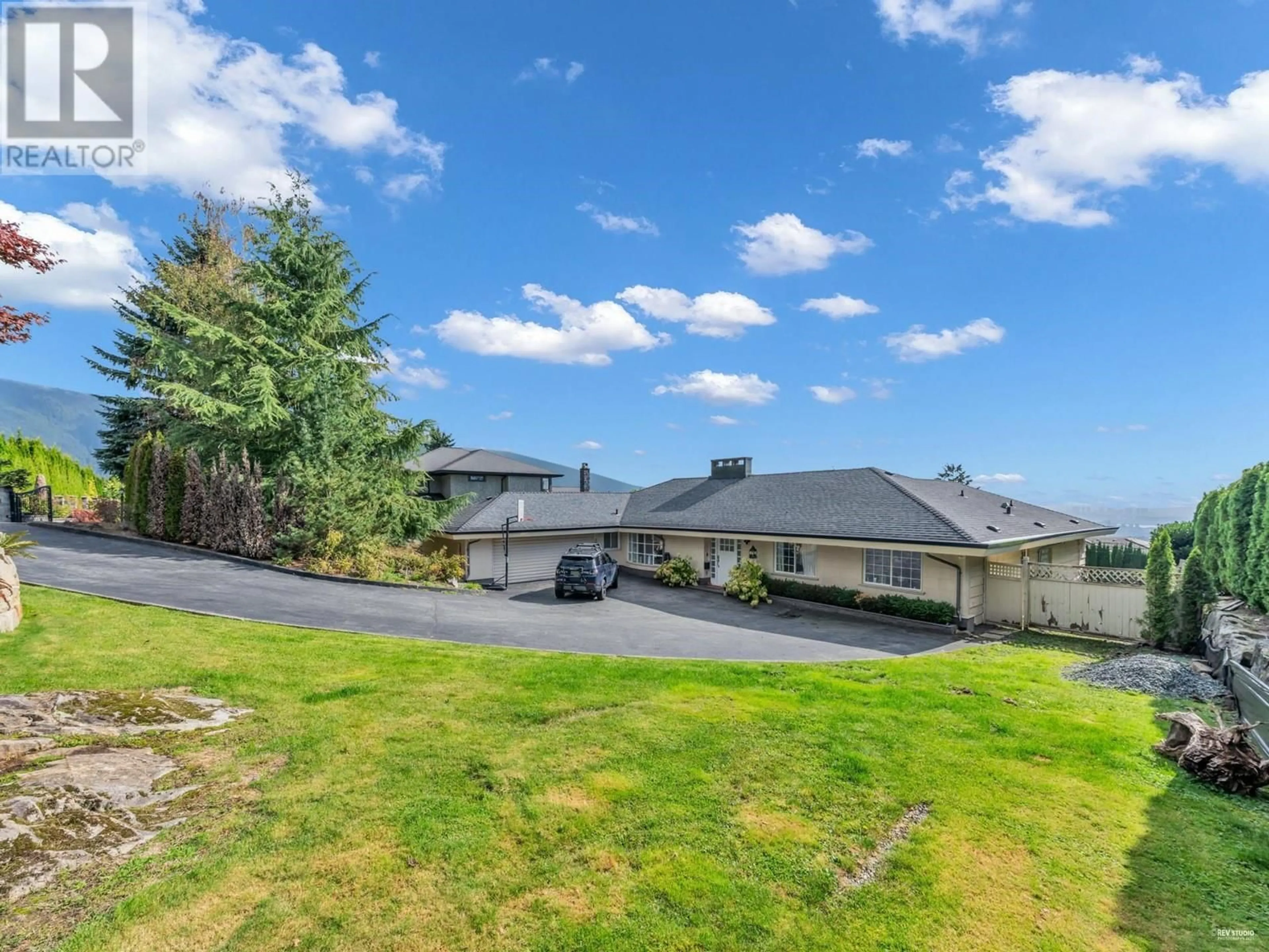 Frontside or backside of a home, the fenced backyard for 1002 EYREMOUNT DRIVE, West Vancouver British Columbia V7S2B3