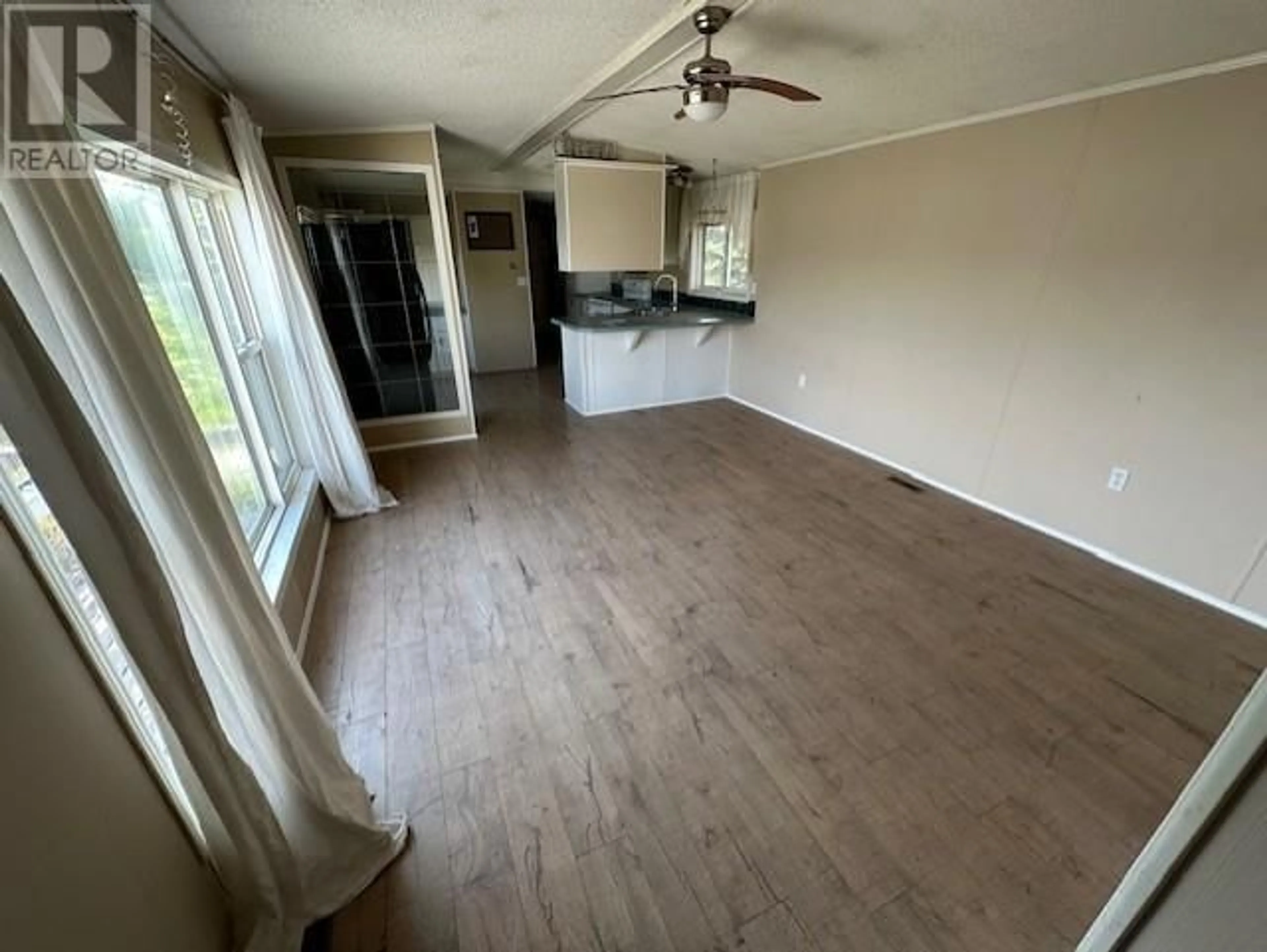 A pic of a room, wood floors for 140 9207 82 STREET, Fort St. John British Columbia V1J5G5