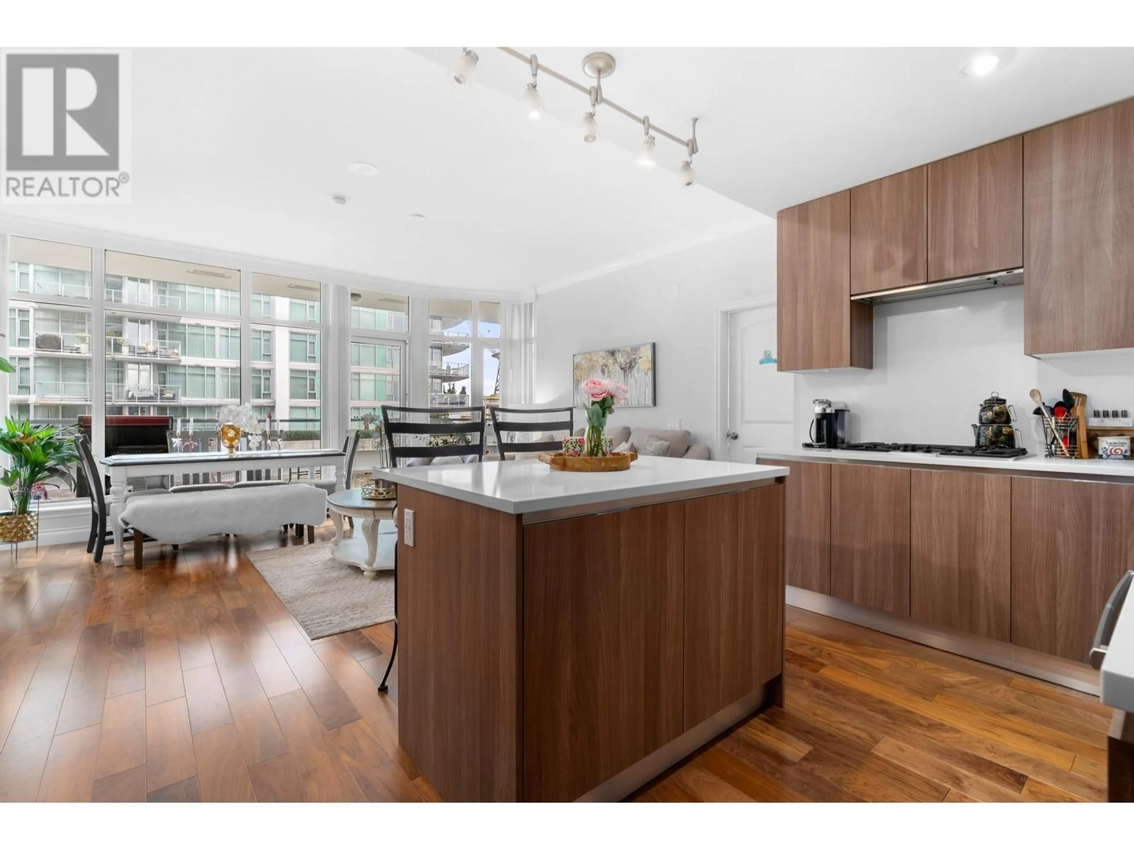 Open concept kitchen, wood/laminate floor for 204 - 175 VICTORY SHIP WAY, North Vancouver British Columbia V7L0G1