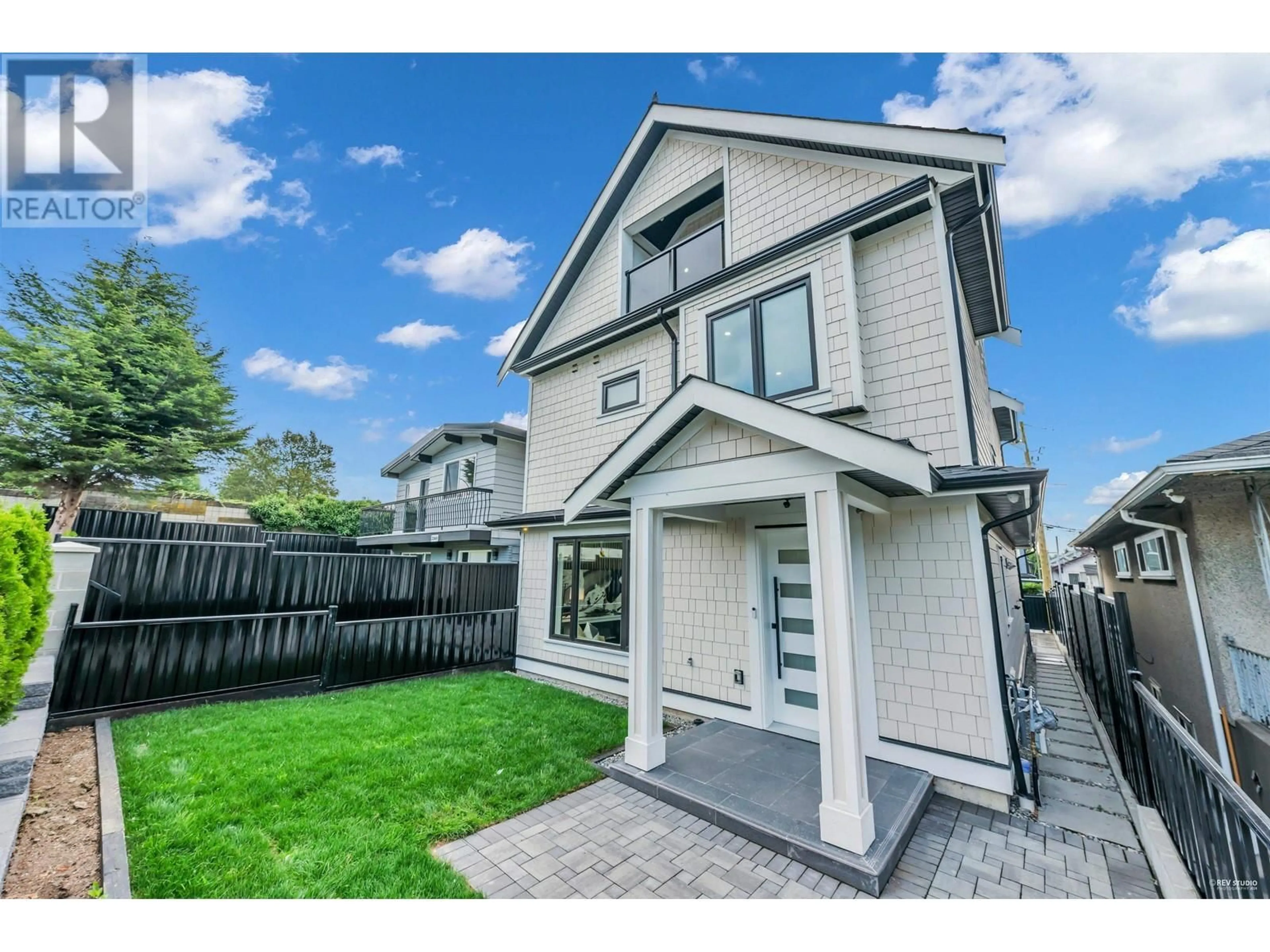 Frontside or backside of a home, the fenced backyard for 2 3344 ADANAC STREET, Vancouver British Columbia V5K2P3