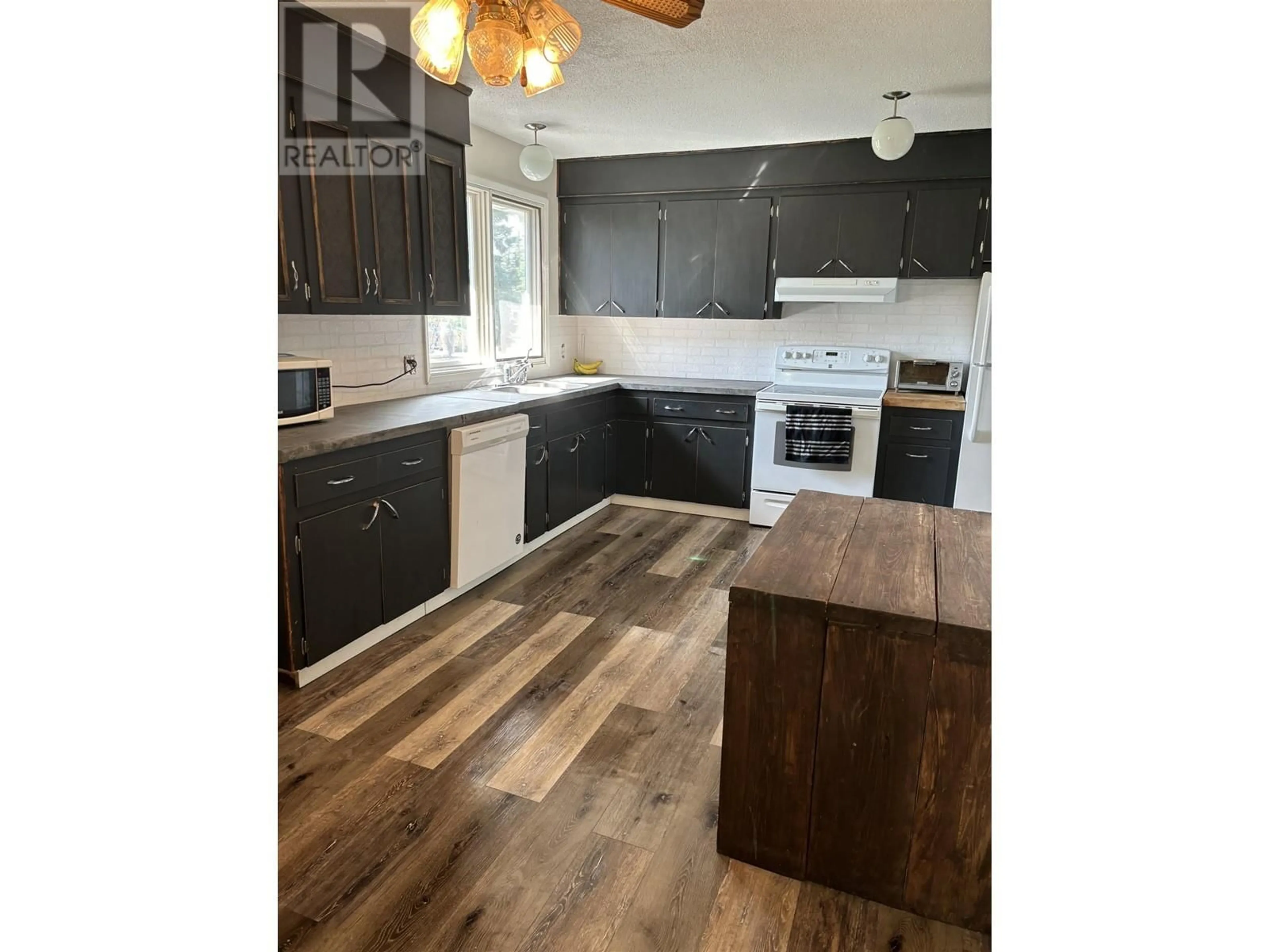 Open concept kitchen, wood/laminate floor for 6365 MARIGOLD AVENUE, Fort St. John British Columbia V1J8B6