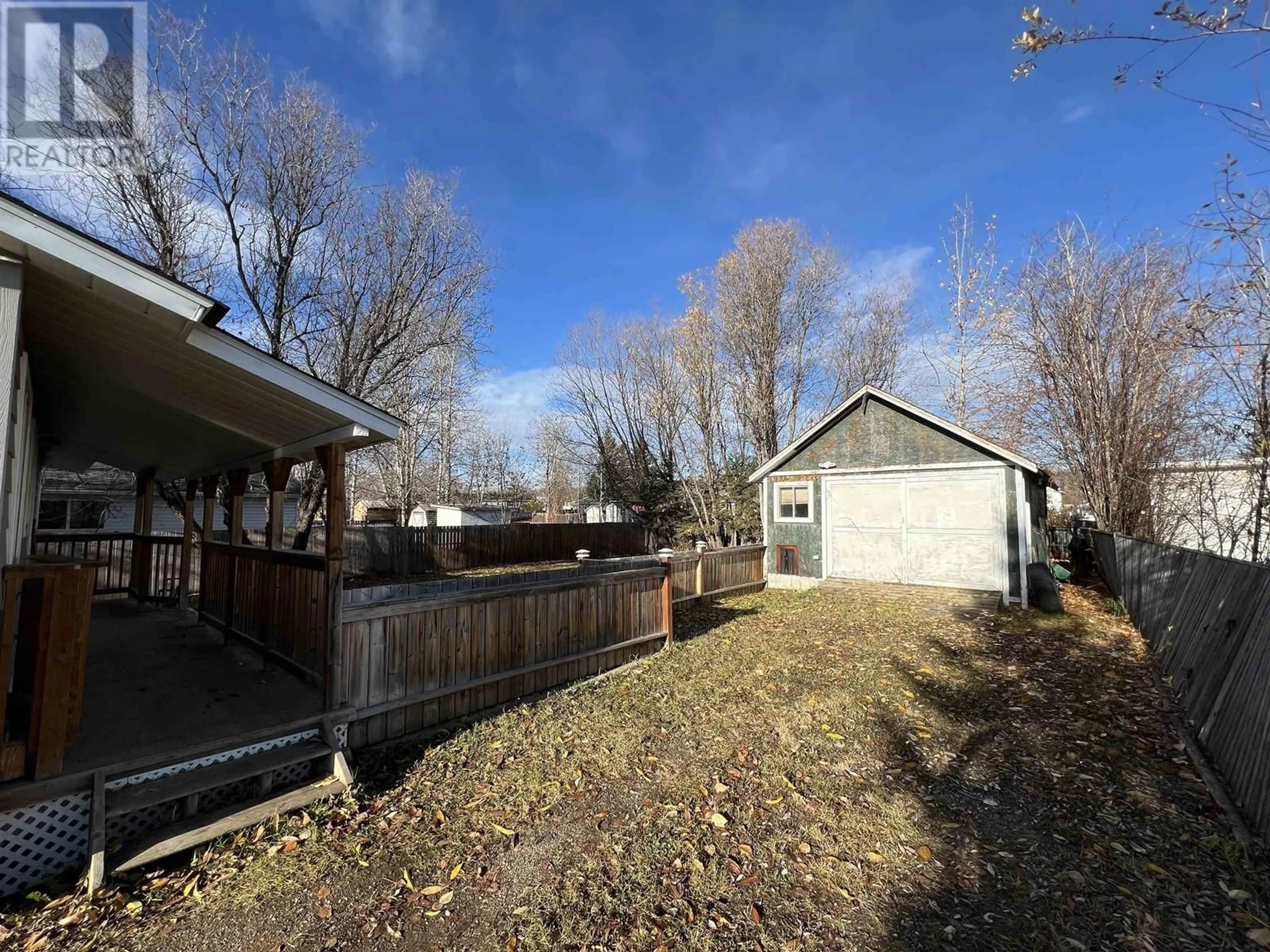 Frontside or backside of a home, the fenced backyard for 3904 E 53 AVENUE, Fort Nelson British Columbia V0C1R0