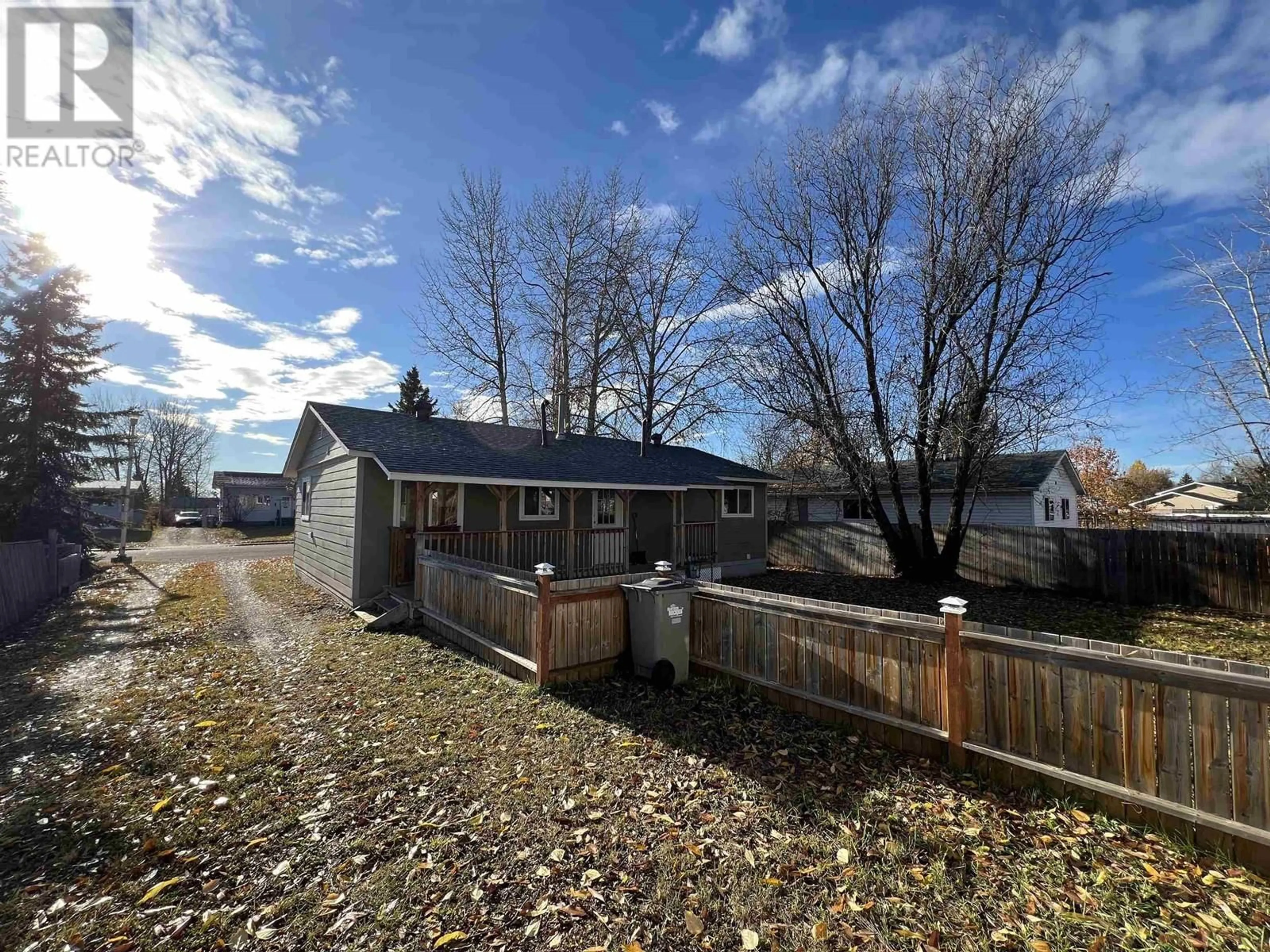 Frontside or backside of a home, the fenced backyard for 3904 E 53 AVENUE, Fort Nelson British Columbia V0C1R0