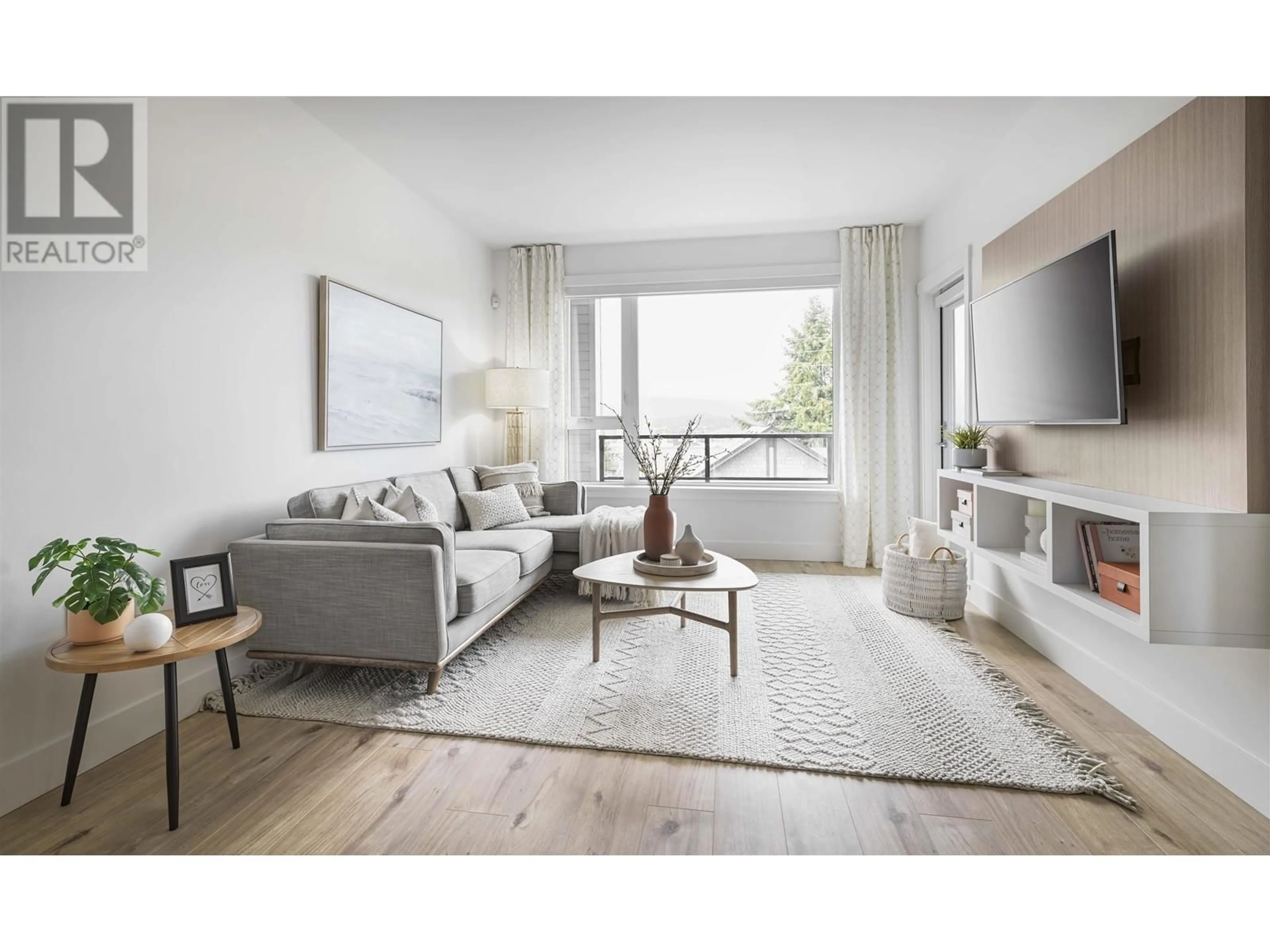 Living room with furniture, wood/laminate floor for 212 - 4788 HASTINGS STREET, Burnaby British Columbia V5C0J7