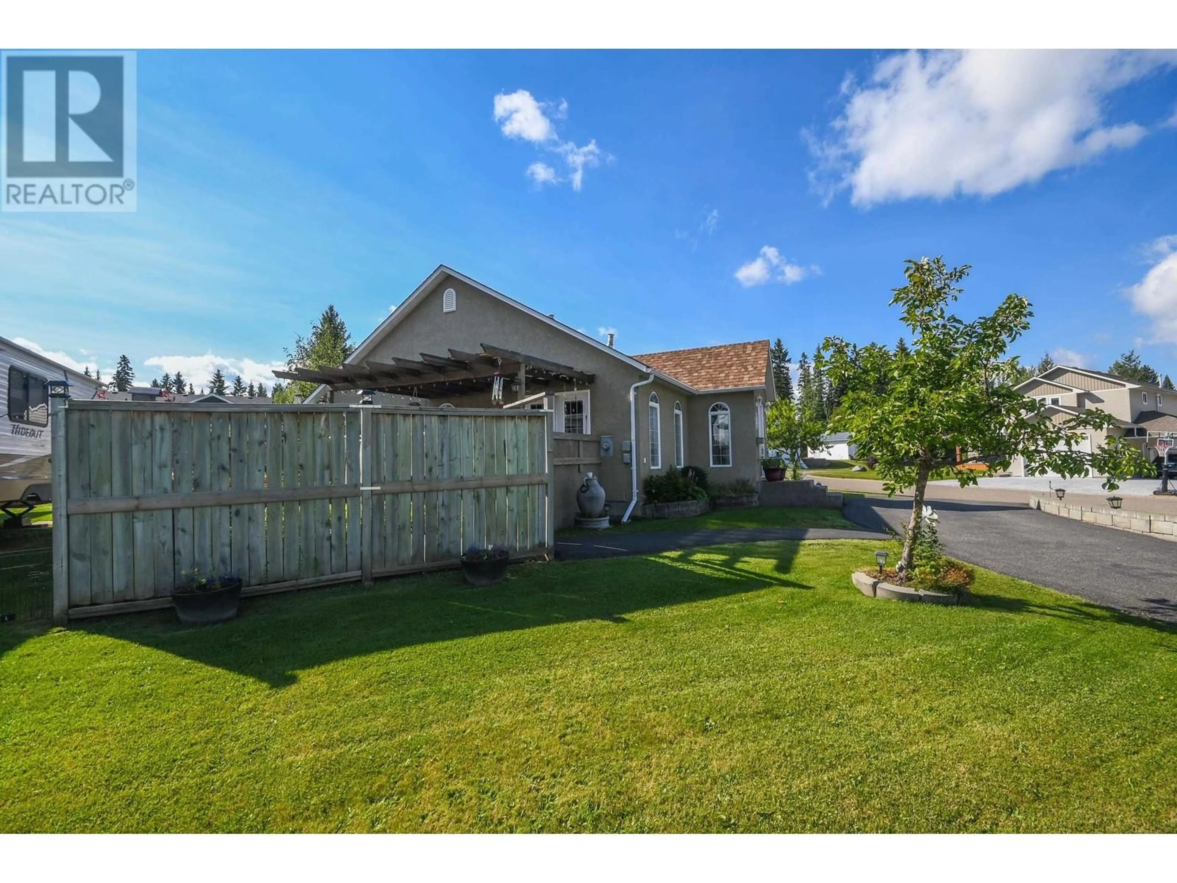 Frontside or backside of a home, the fenced backyard for 5716 BEARSPAW CRESCENT, Prince George British Columbia V2N6P7