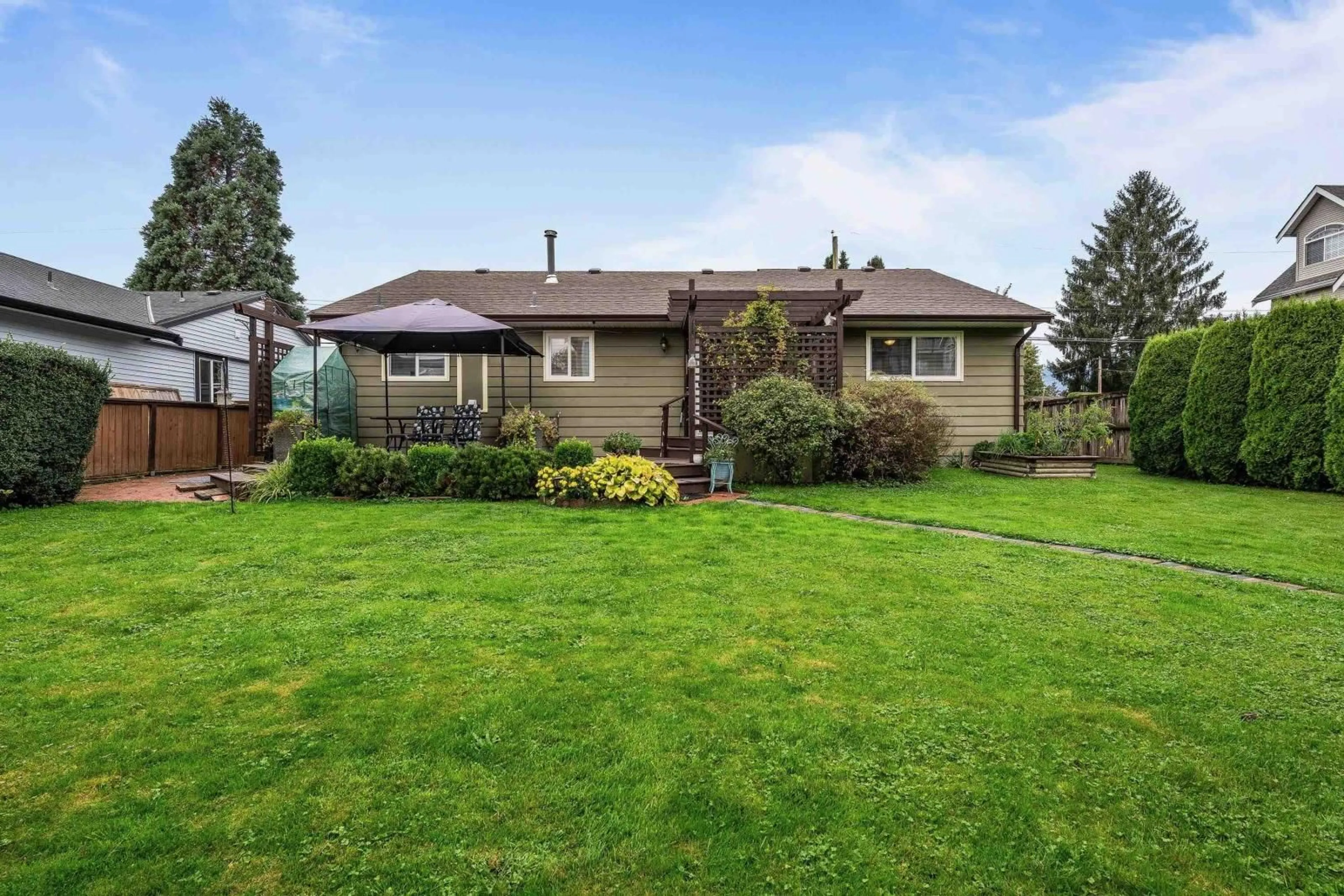 Frontside or backside of a home, the fenced backyard for 9460 WOODBINE STREET, Chilliwack British Columbia V2P5S4