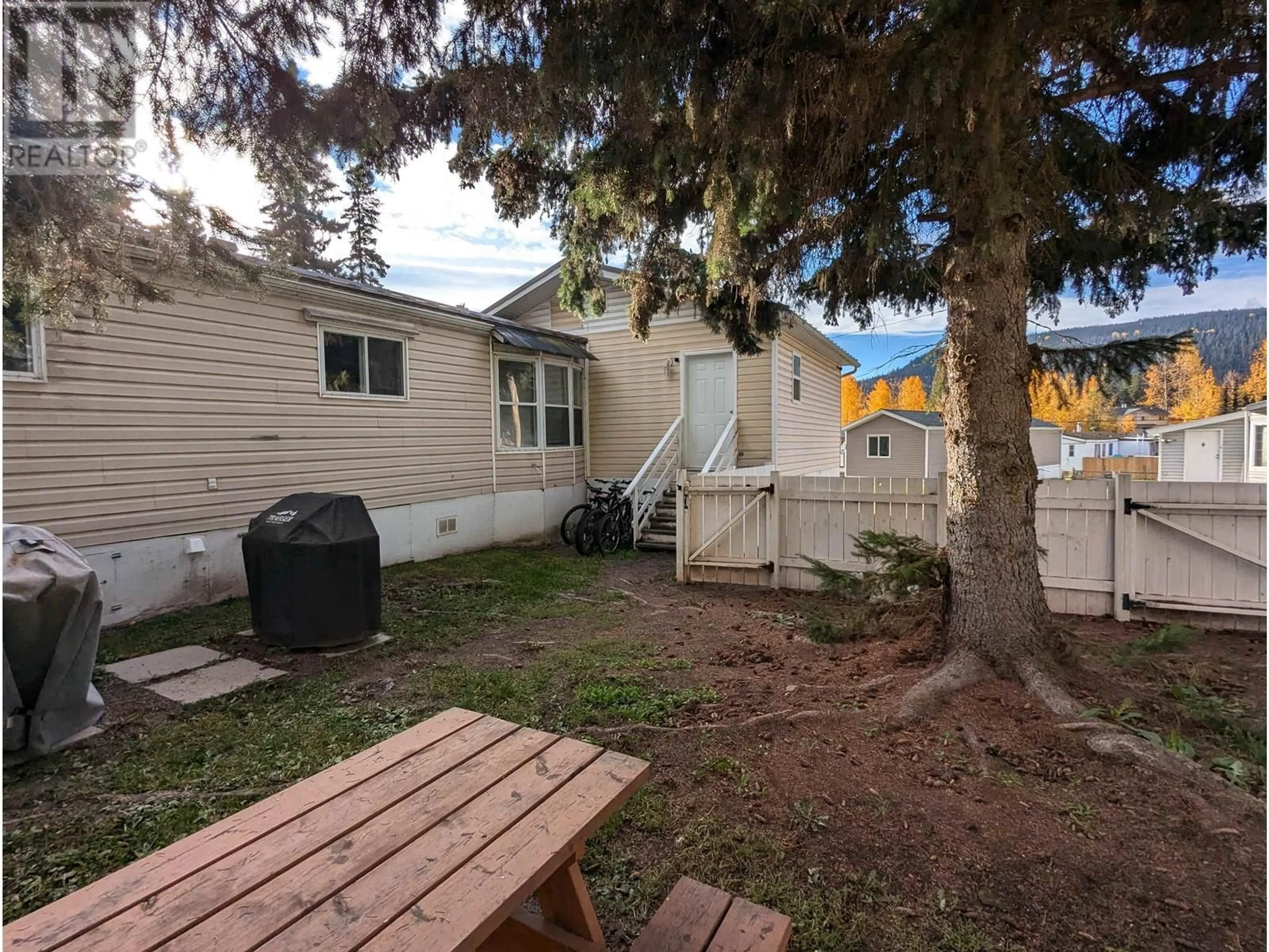 A pic from exterior of the house or condo, the fenced backyard for 75 4430 16 HIGHWAY, Smithers British Columbia V0J2N0