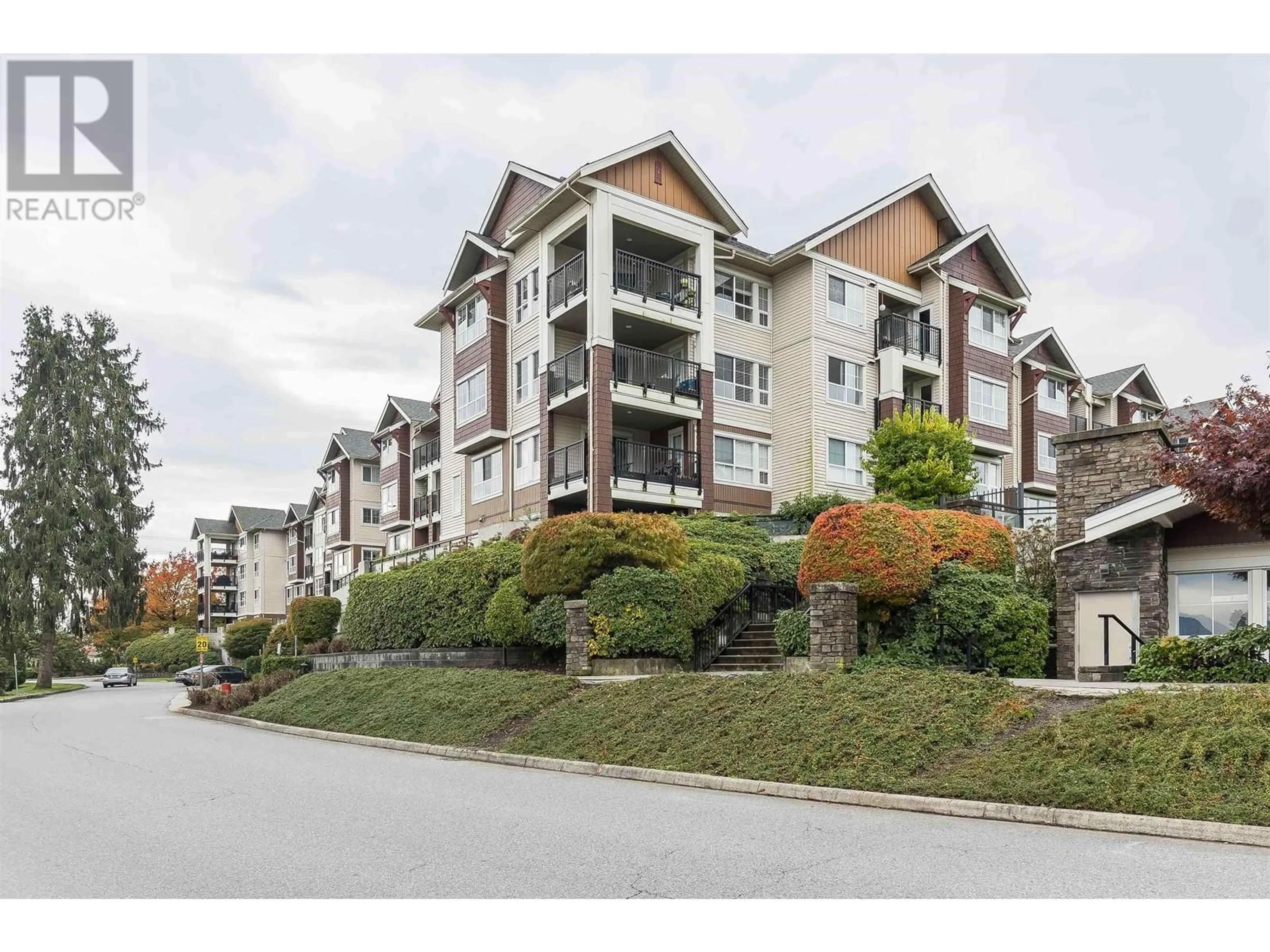 A pic from exterior of the house or condo, the street view for 305 19677 MEADOW GARDENS WAY, Pitt Meadows British Columbia V3Y0A2