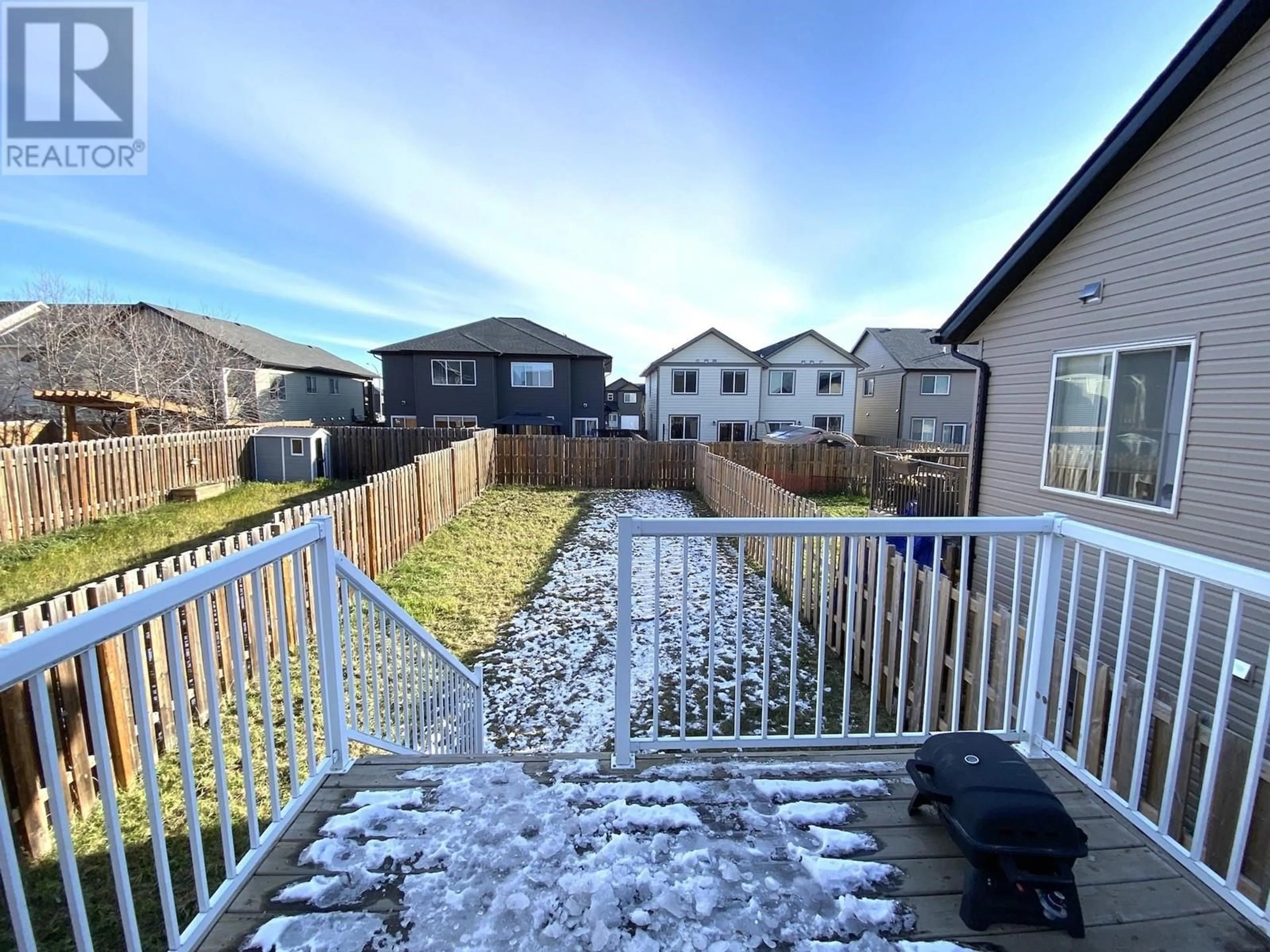 Frontside or backside of a home, the fenced backyard for 8623 83 STREET, Fort St. John British Columbia V1J0G8