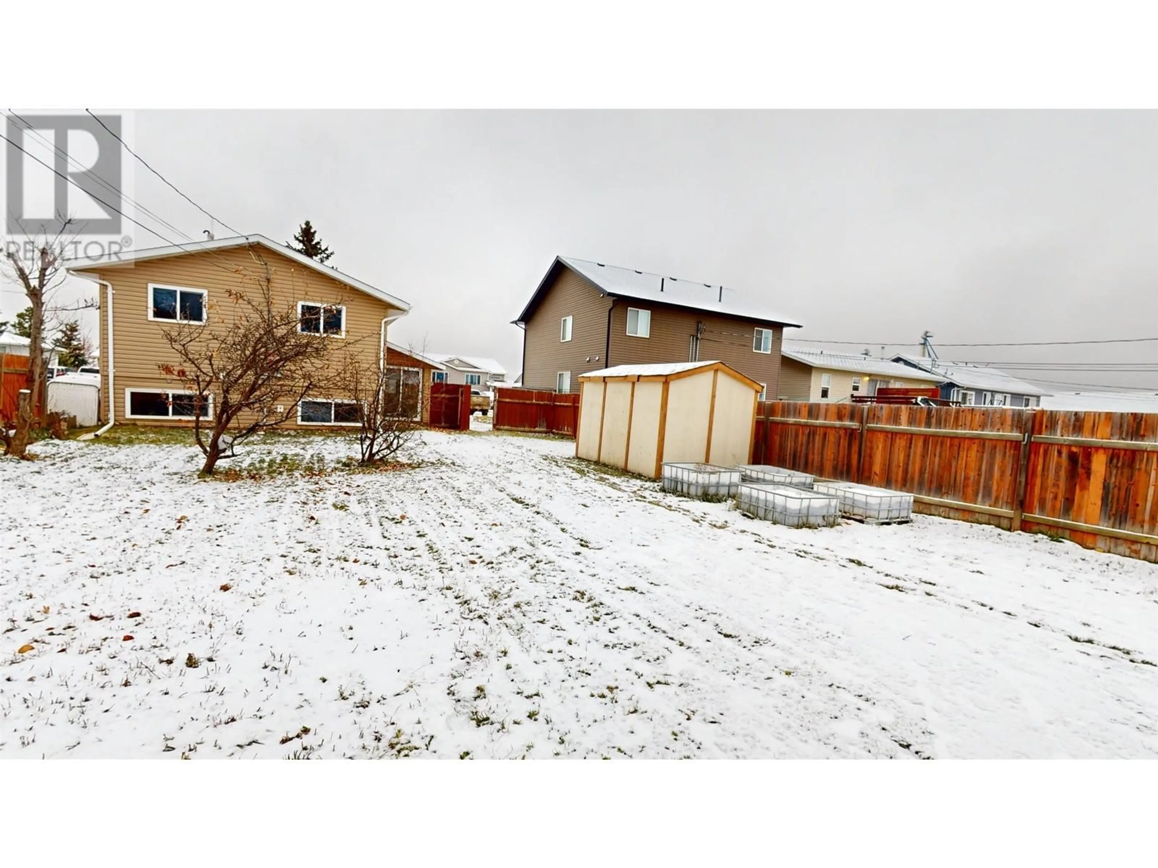 Frontside or backside of a home, the fenced backyard for 7919 97 AVENUE, Fort St. John British Columbia V1J1L7