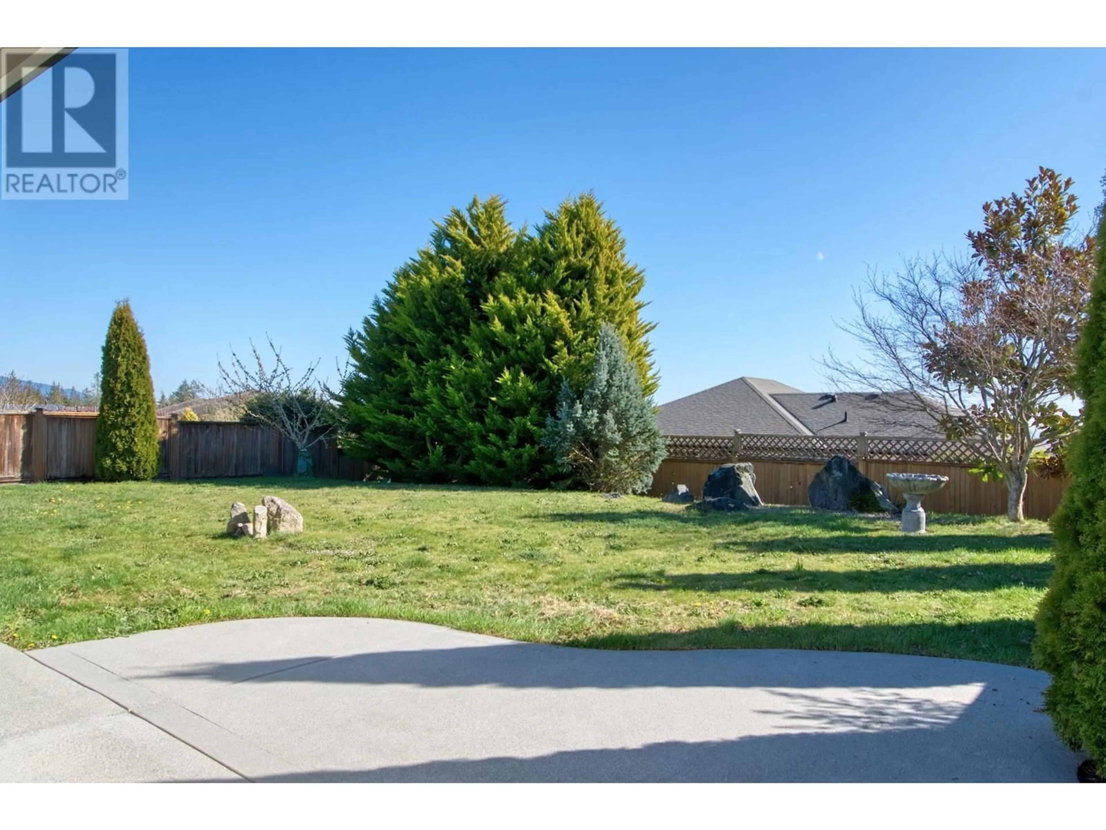 Frontside or backside of a home, the fenced backyard for 6257 KEVINS ROAD, Sechelt British Columbia V7Z0V2