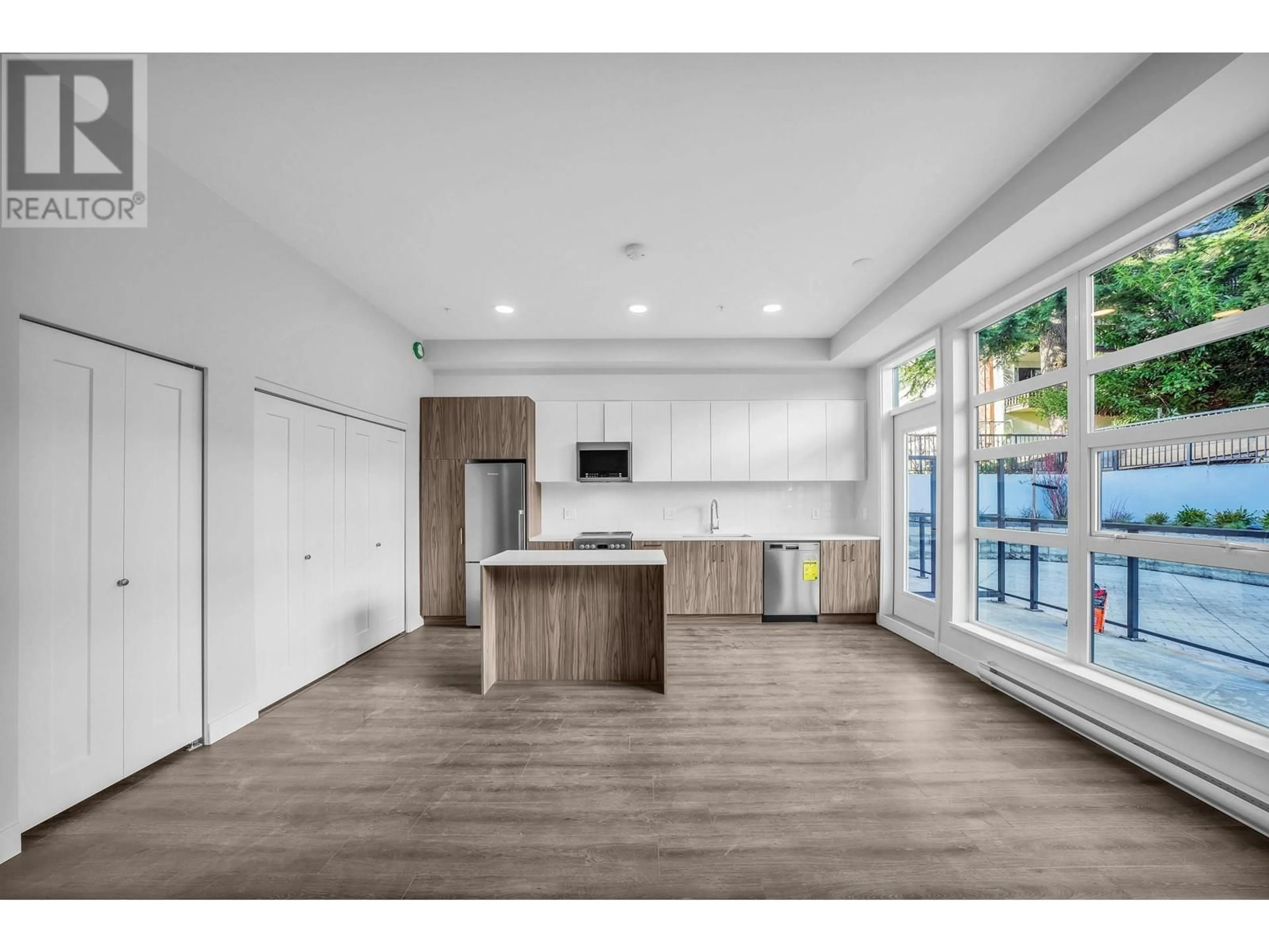 Open concept kitchen, wood/laminate floor for 202 - 5535 HASTINGS STREET, Burnaby British Columbia V5B1R2