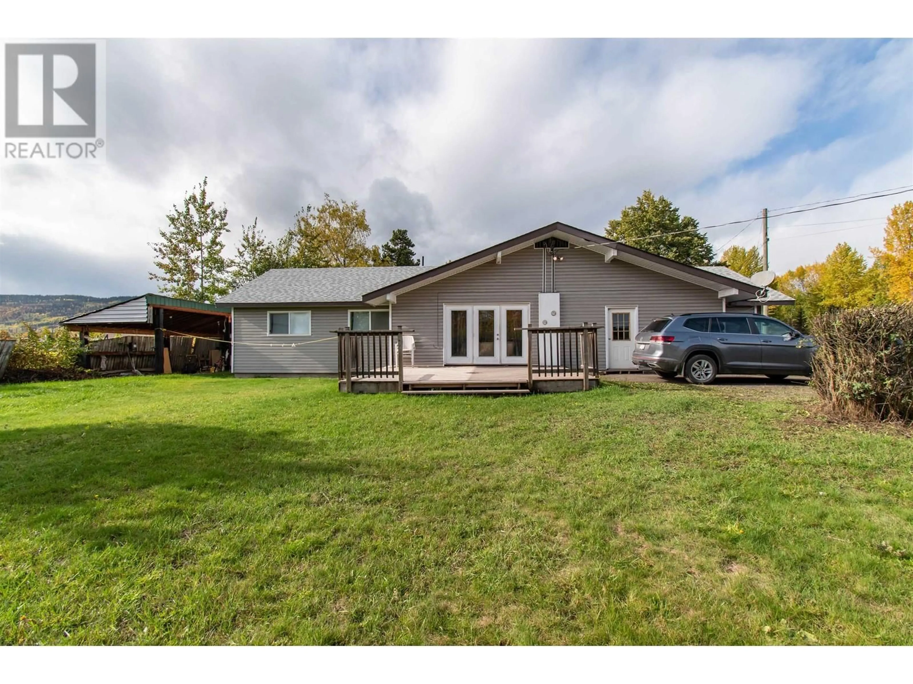 Frontside or backside of a home, the fenced backyard for 2088 CARNABY STREET, Smithers British Columbia V0J2N0