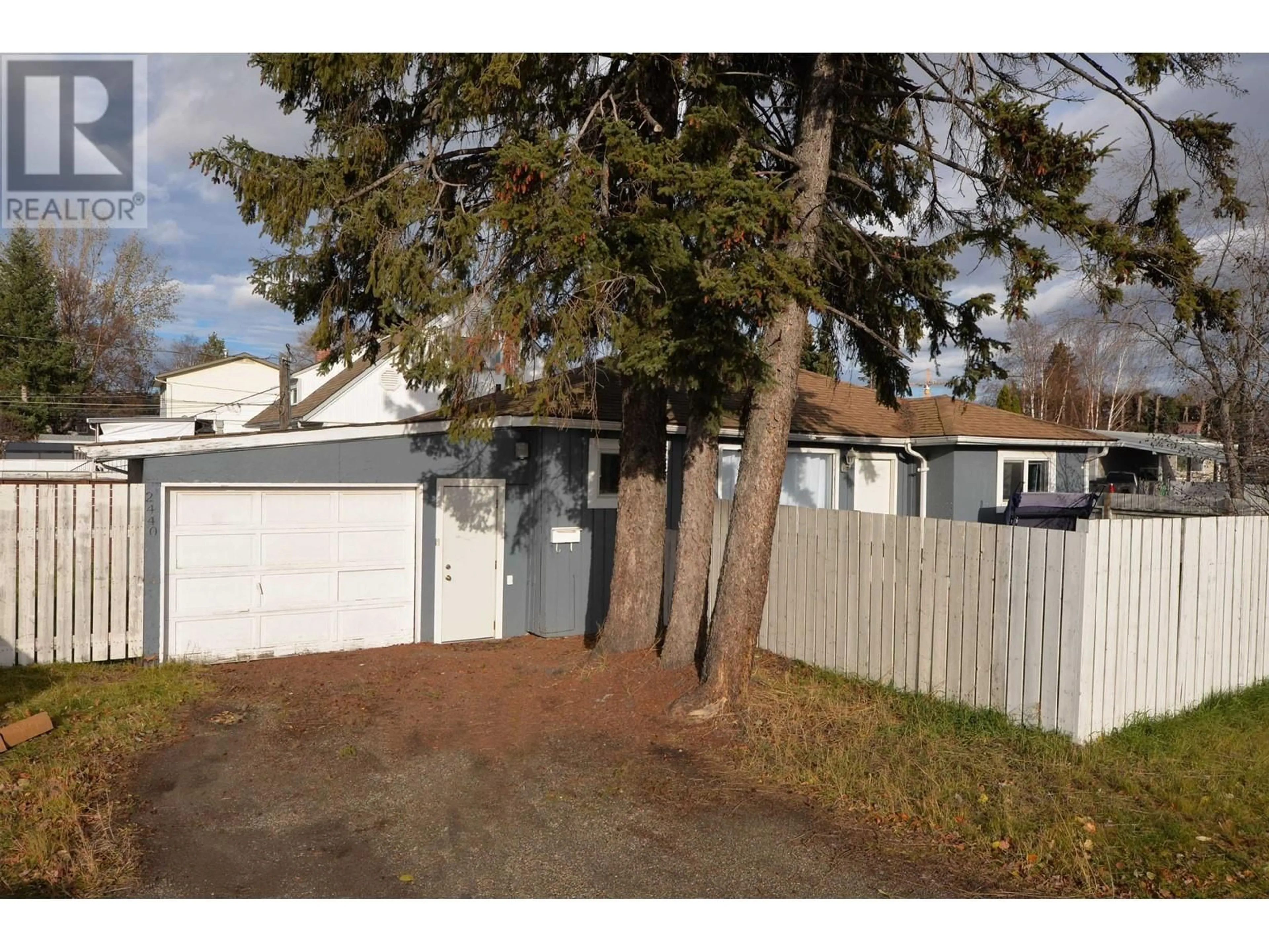 Frontside or backside of a home, the fenced backyard for 2440 15TH AVENUE, Prince George British Columbia V2M1S6