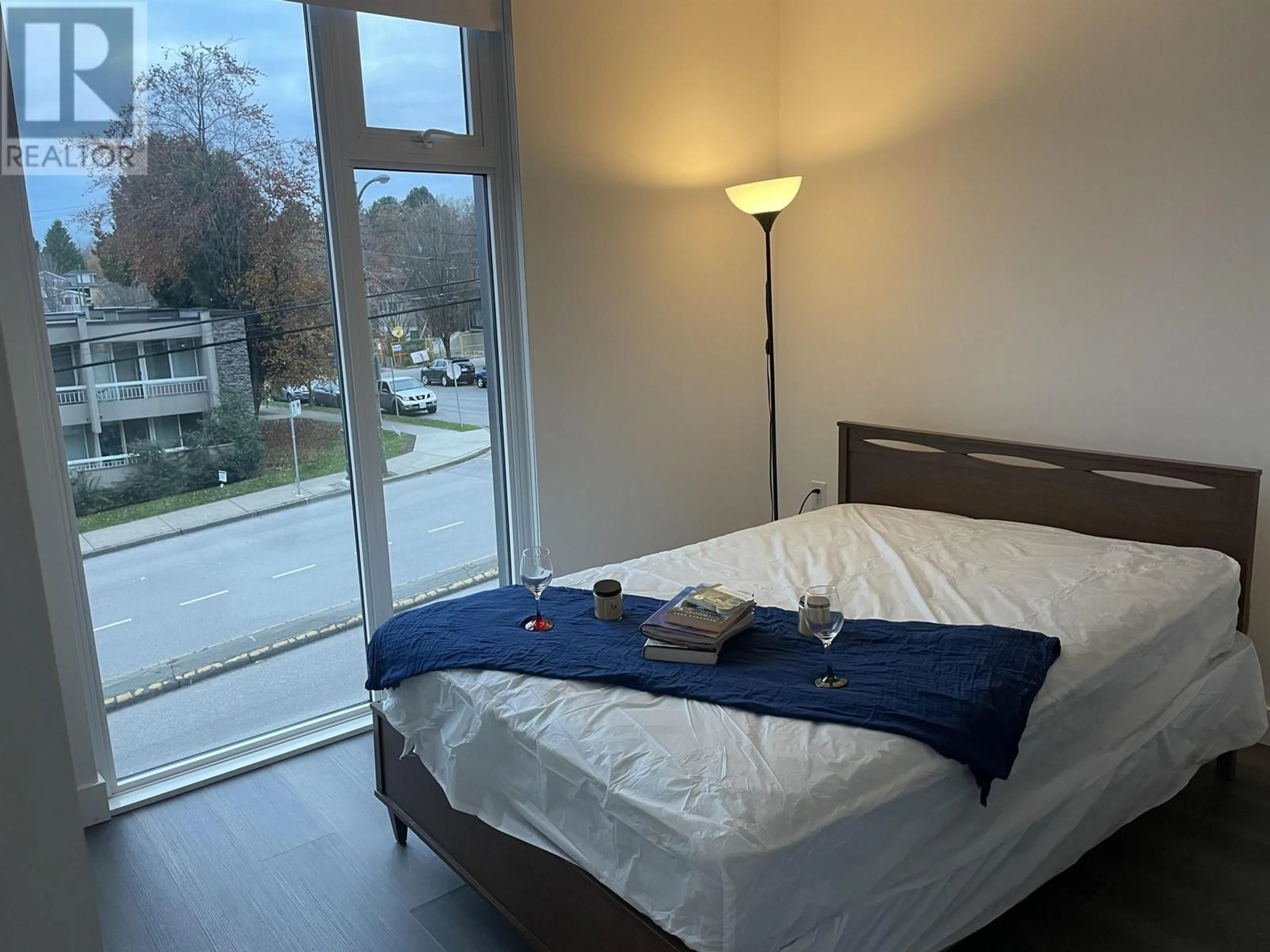 Bedroom with bed, wood/laminate floor for 210 - 8138 FRASER STREET, Vancouver British Columbia V5X0J8