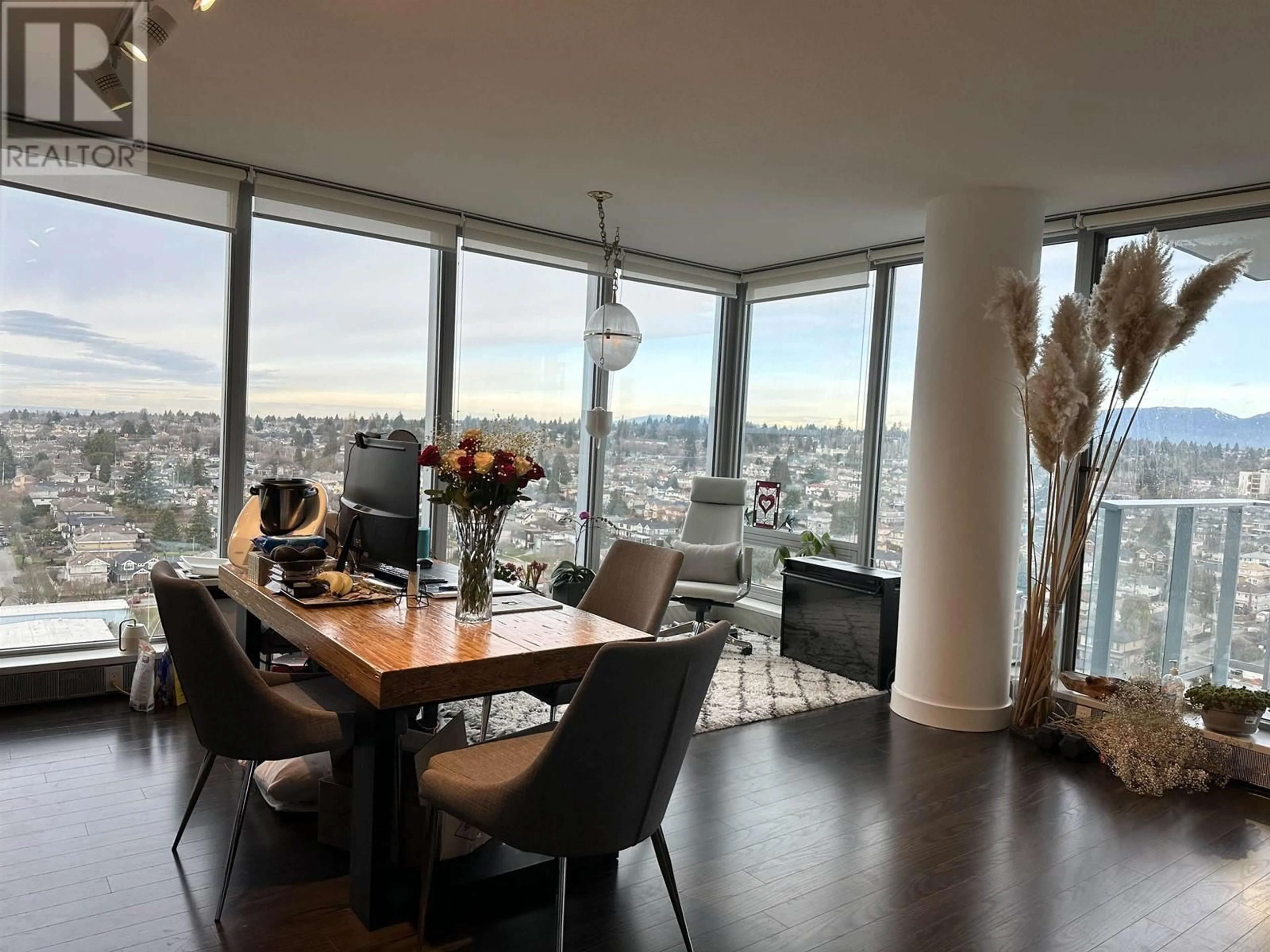 Dining room, wood floors, the view of city buildings for 2502 8131 NUNAVUT LANE, Vancouver British Columbia V5X0E2