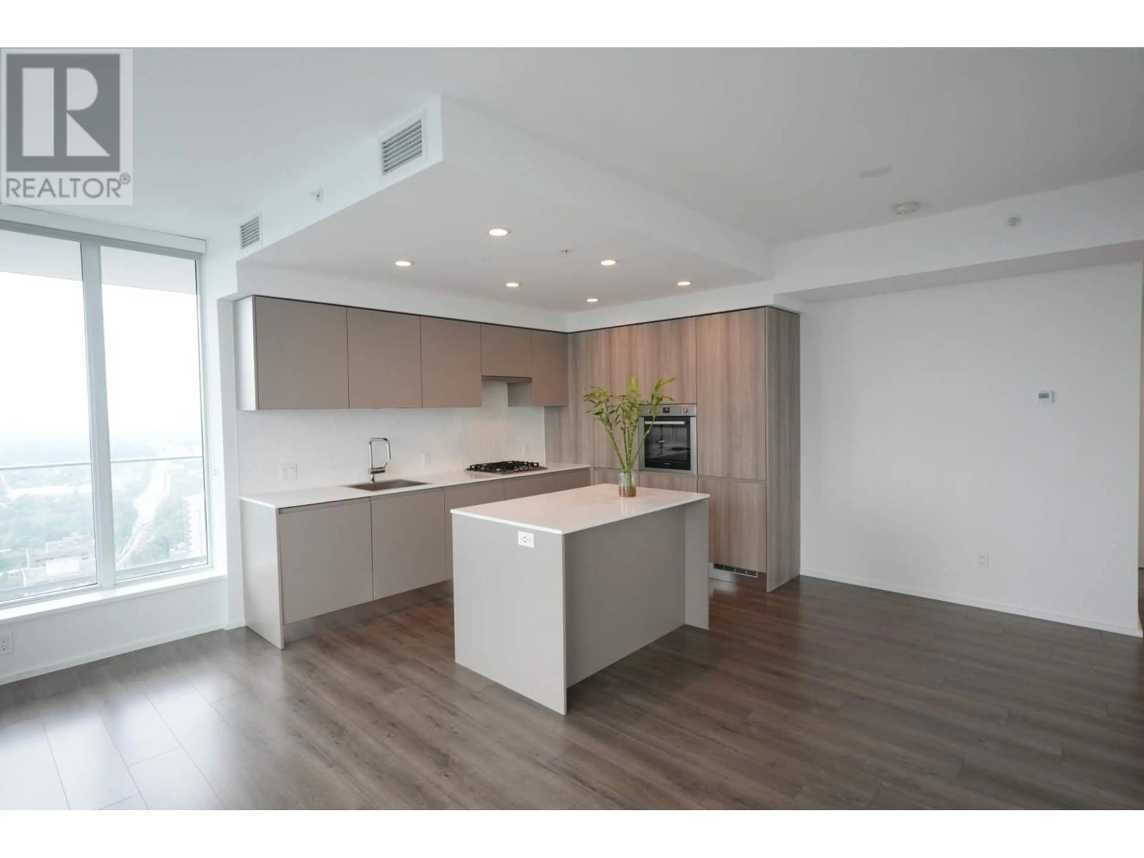 Open concept kitchen, wood/laminate floor for 4207 3809 EVERGREEN PLACE, Burnaby British Columbia V3J0M1