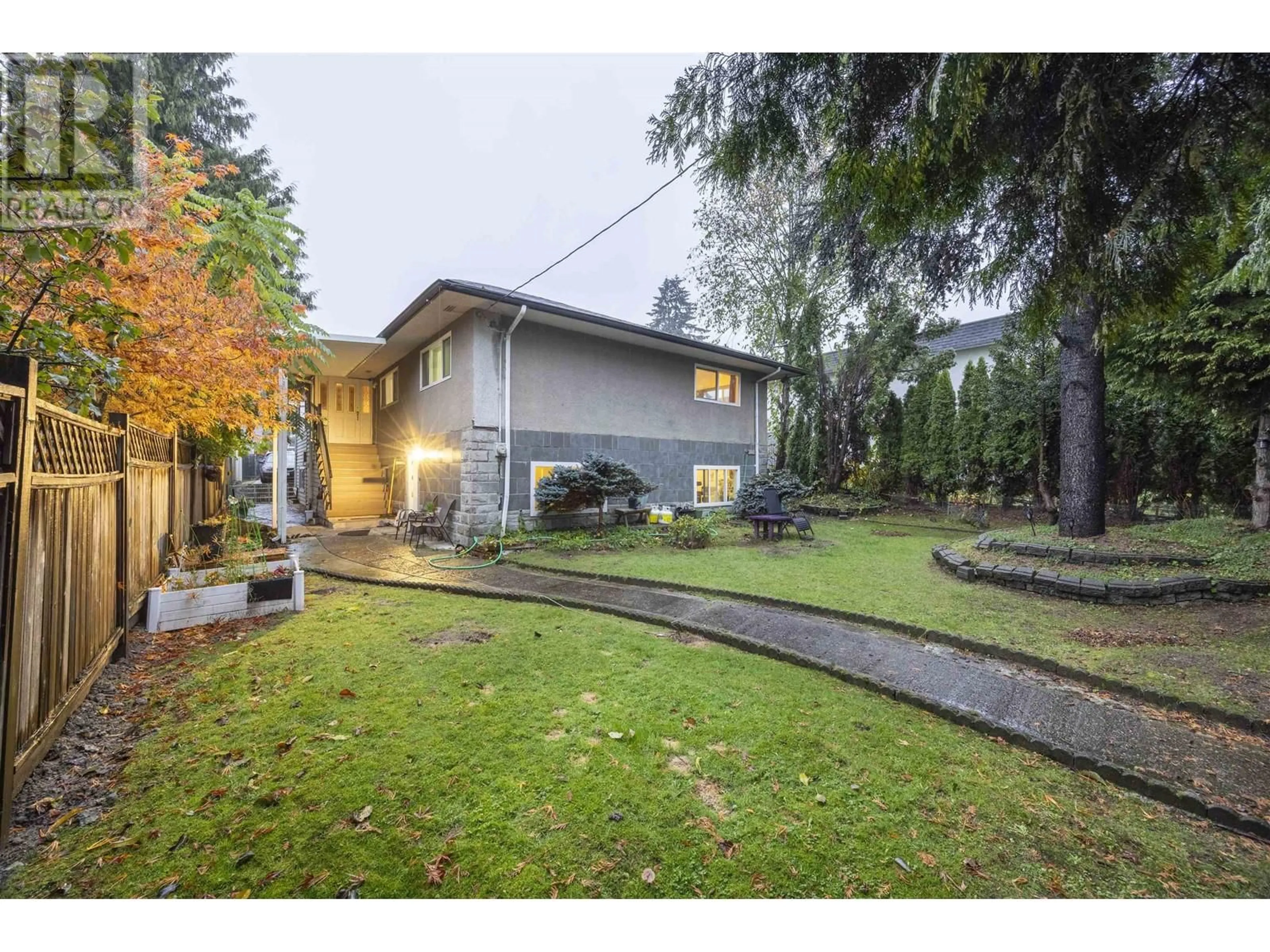 Frontside or backside of a home, the fenced backyard for 1215 COMO LAKE AVENUE, Coquitlam British Columbia V3J7R5