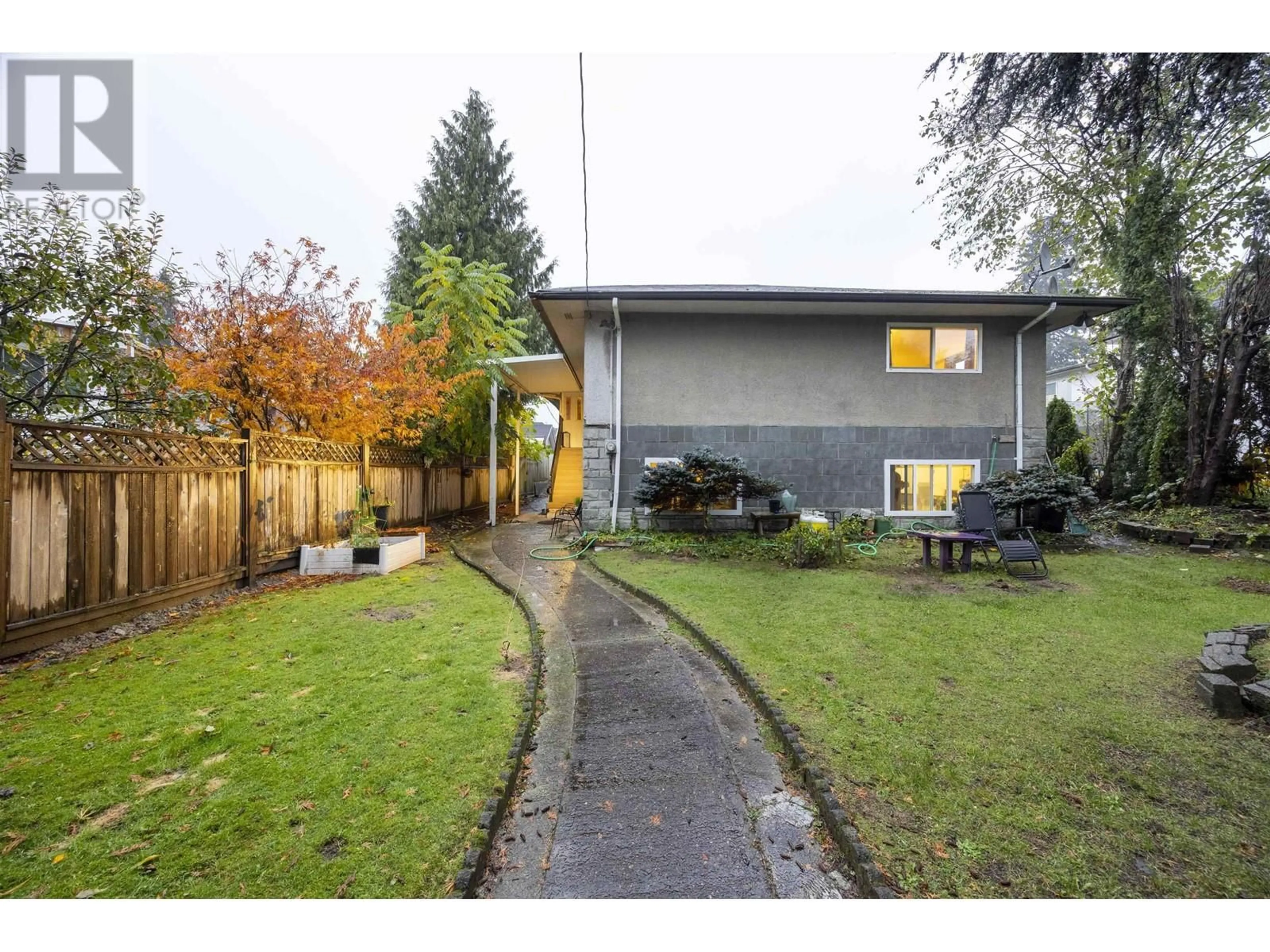 Frontside or backside of a home, the fenced backyard for 1215 COMO LAKE AVENUE, Coquitlam British Columbia V3J7R5