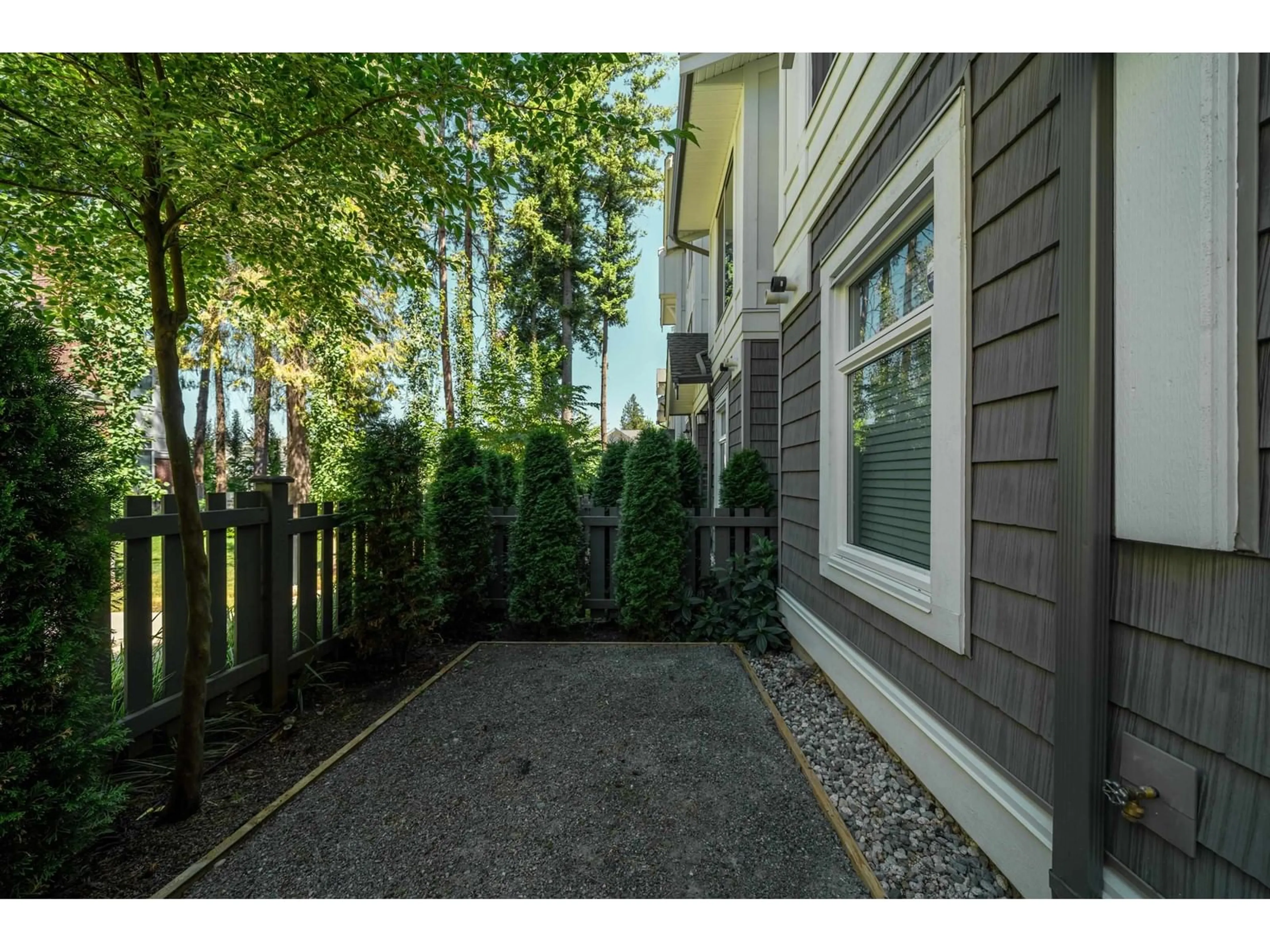 A pic from exterior of the house or condo, the fenced backyard for 170 9718 161A STREET, Surrey British Columbia V4N6S7