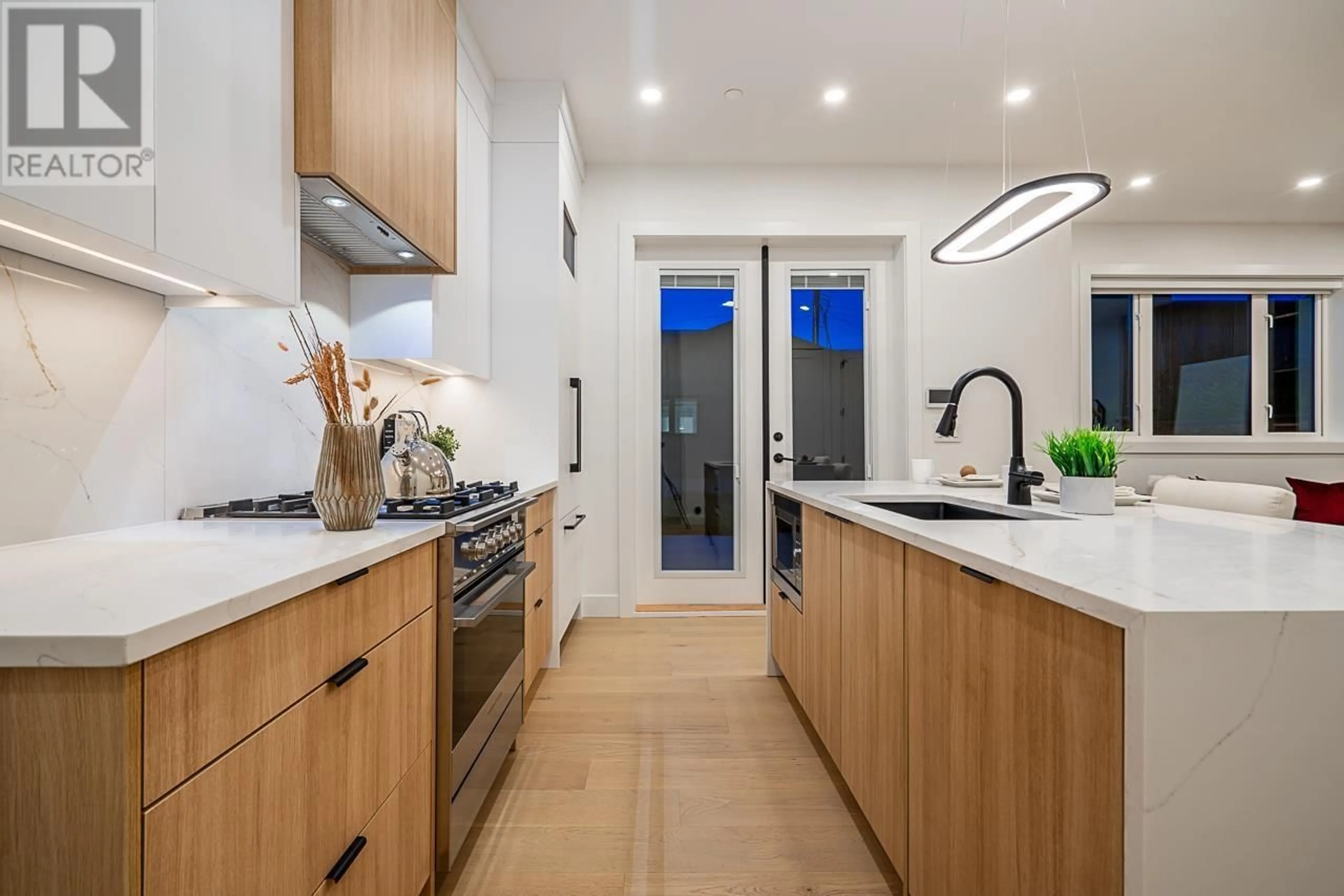 Contemporary kitchen, wood floors for 2 2715 E PENDER STREET, Vancouver British Columbia V5K2B9