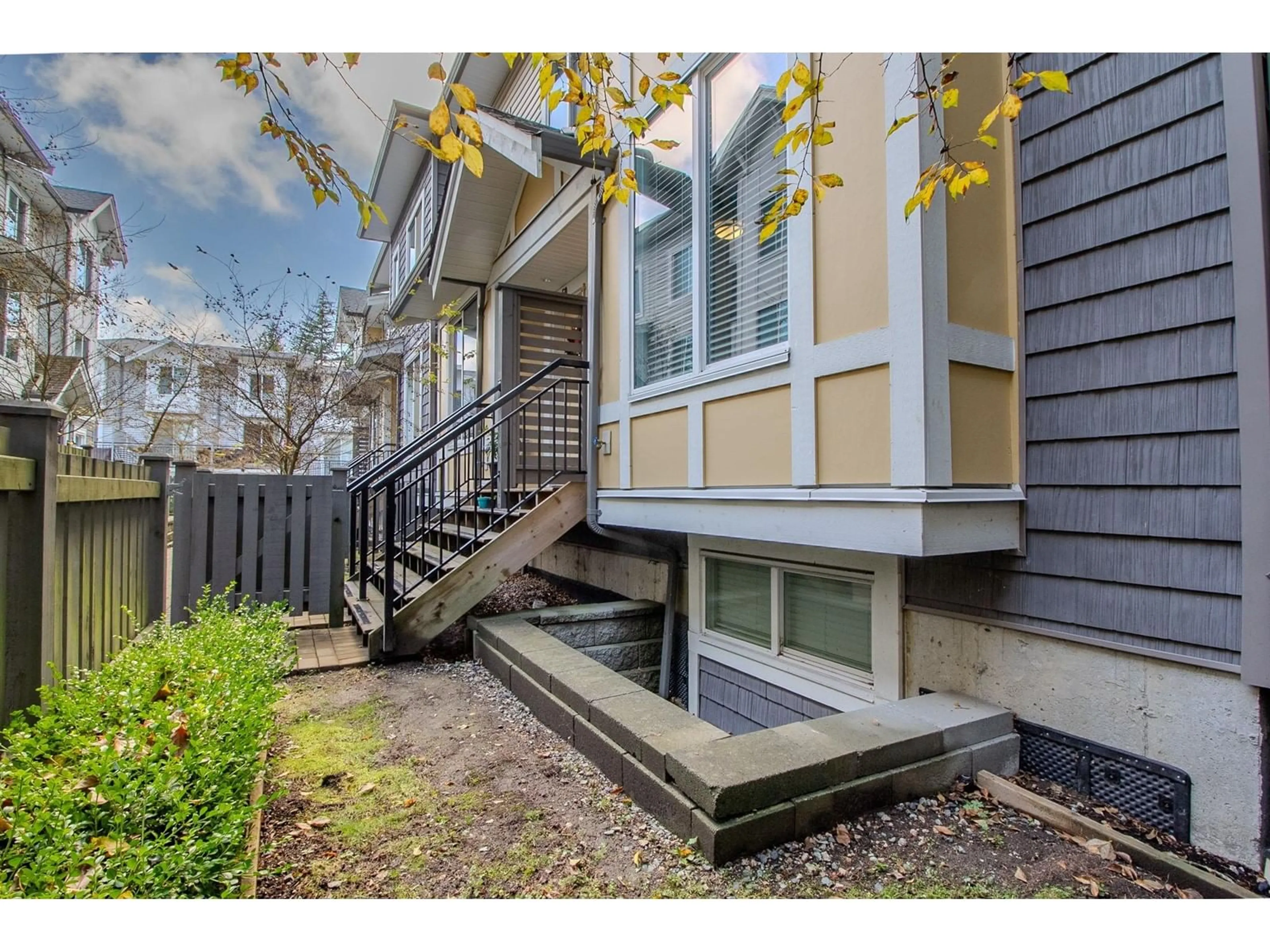 A pic from exterior of the house or condo, the fenced backyard for 49 9718 161A STREET, Surrey British Columbia V4N6S7