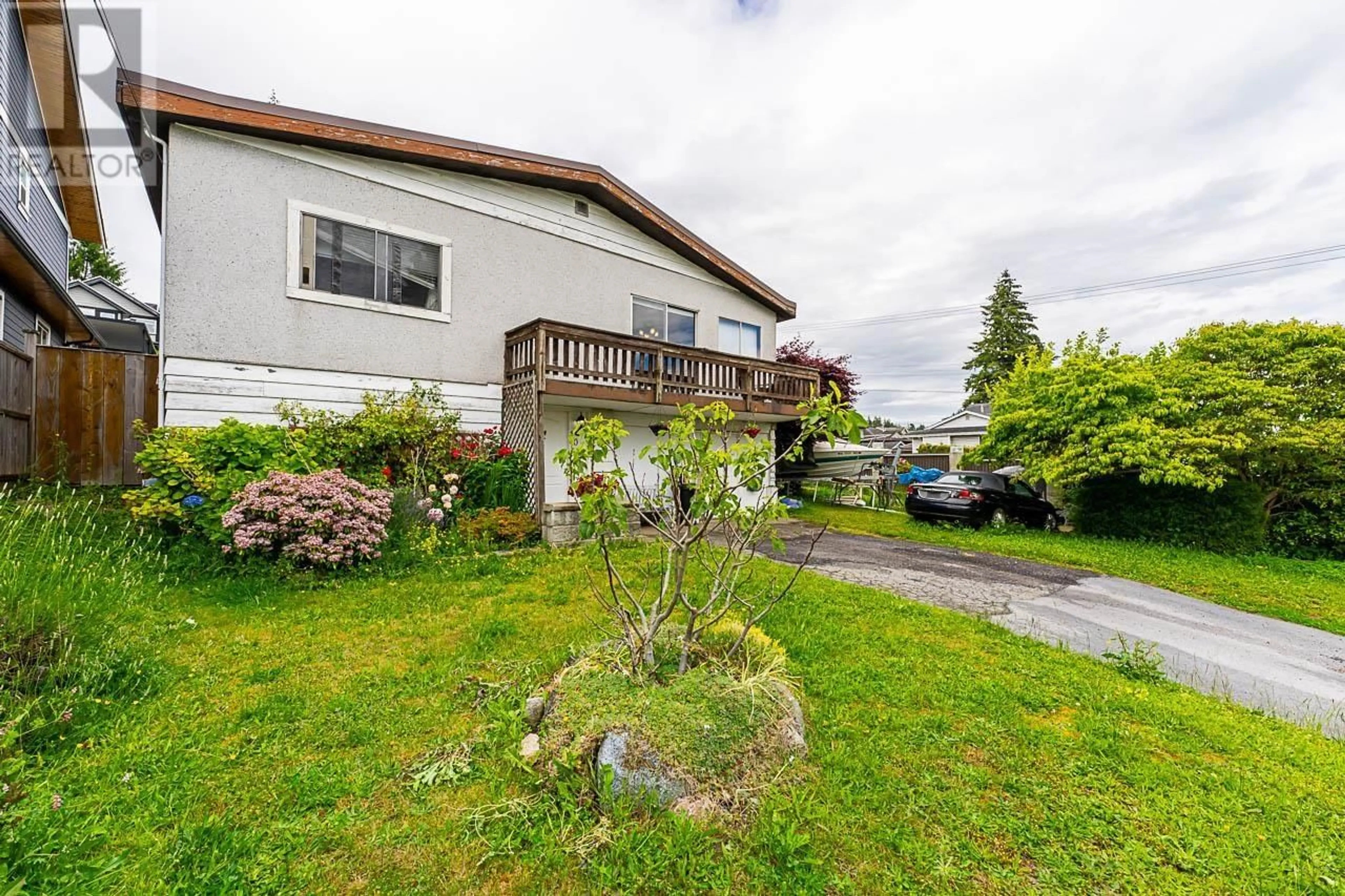 Frontside or backside of a home, the fenced backyard for 1031 STEWART AVENUE, Coquitlam British Columbia V3K2N7