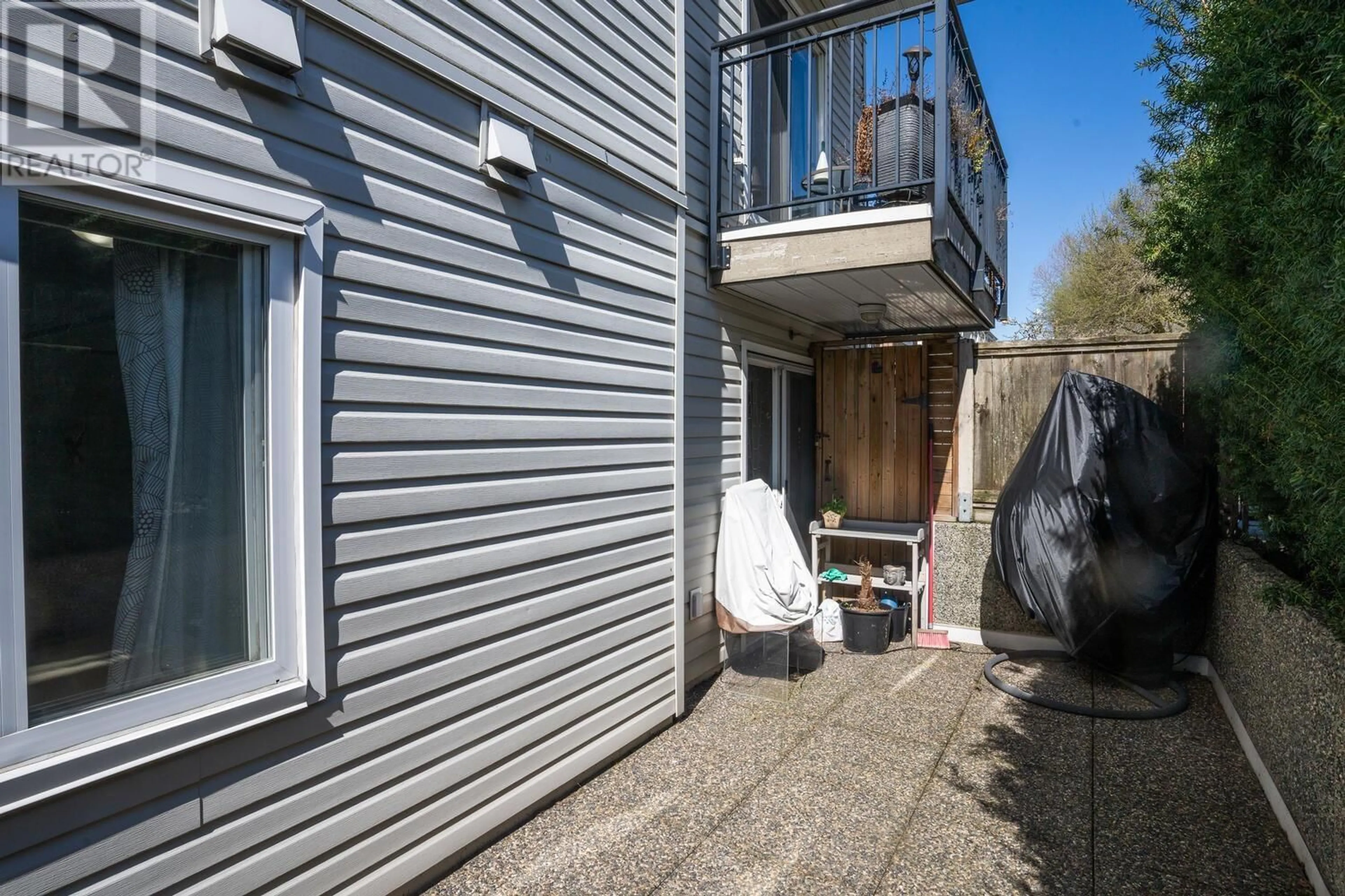 A pic from exterior of the house or condo, the fenced backyard for 102 1445 W 70TH AVENUE, Vancouver British Columbia V6P2Z3