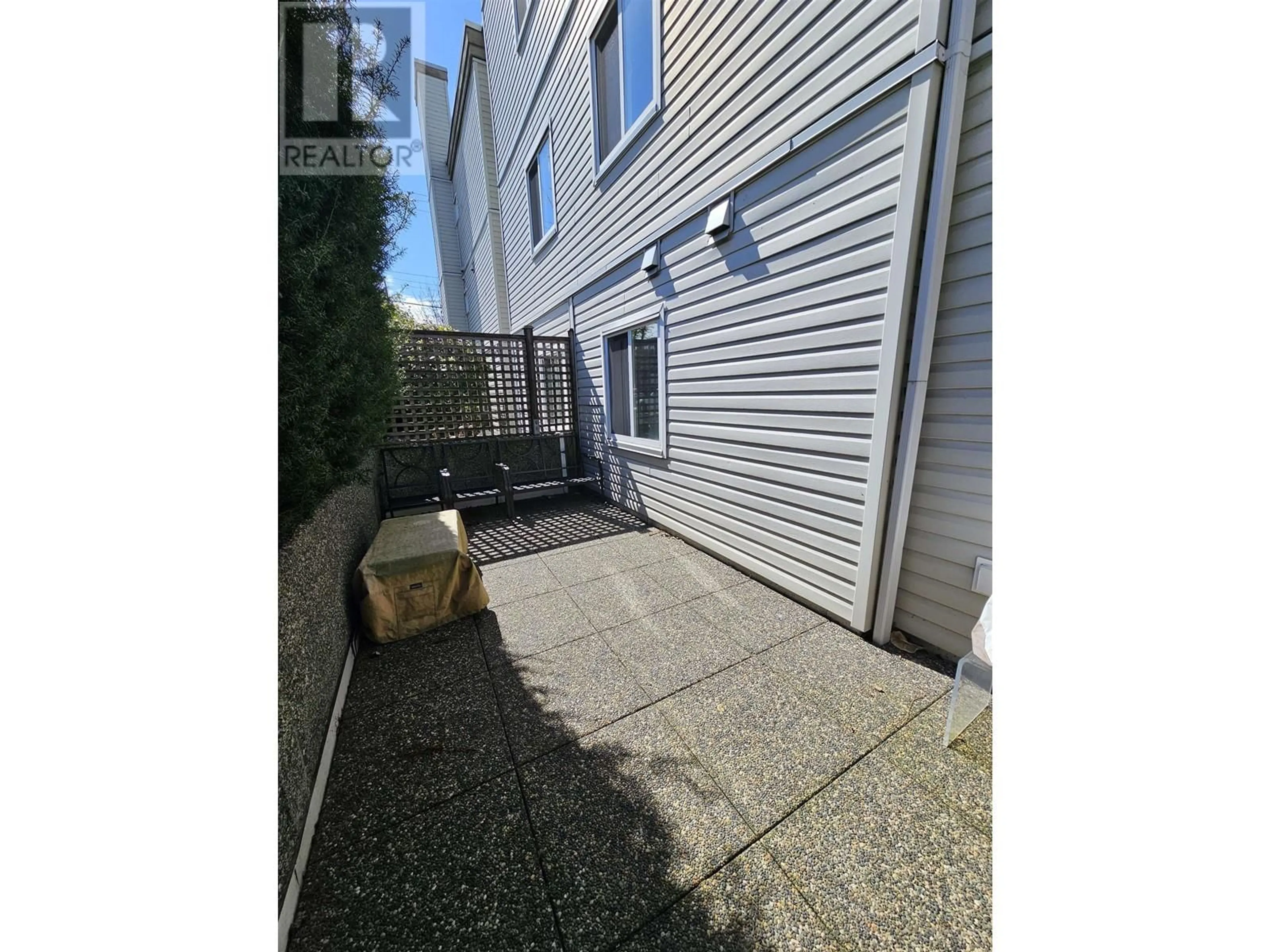 A pic from exterior of the house or condo, the fenced backyard for 102 1445 W 70TH AVENUE, Vancouver British Columbia V6P2Z3