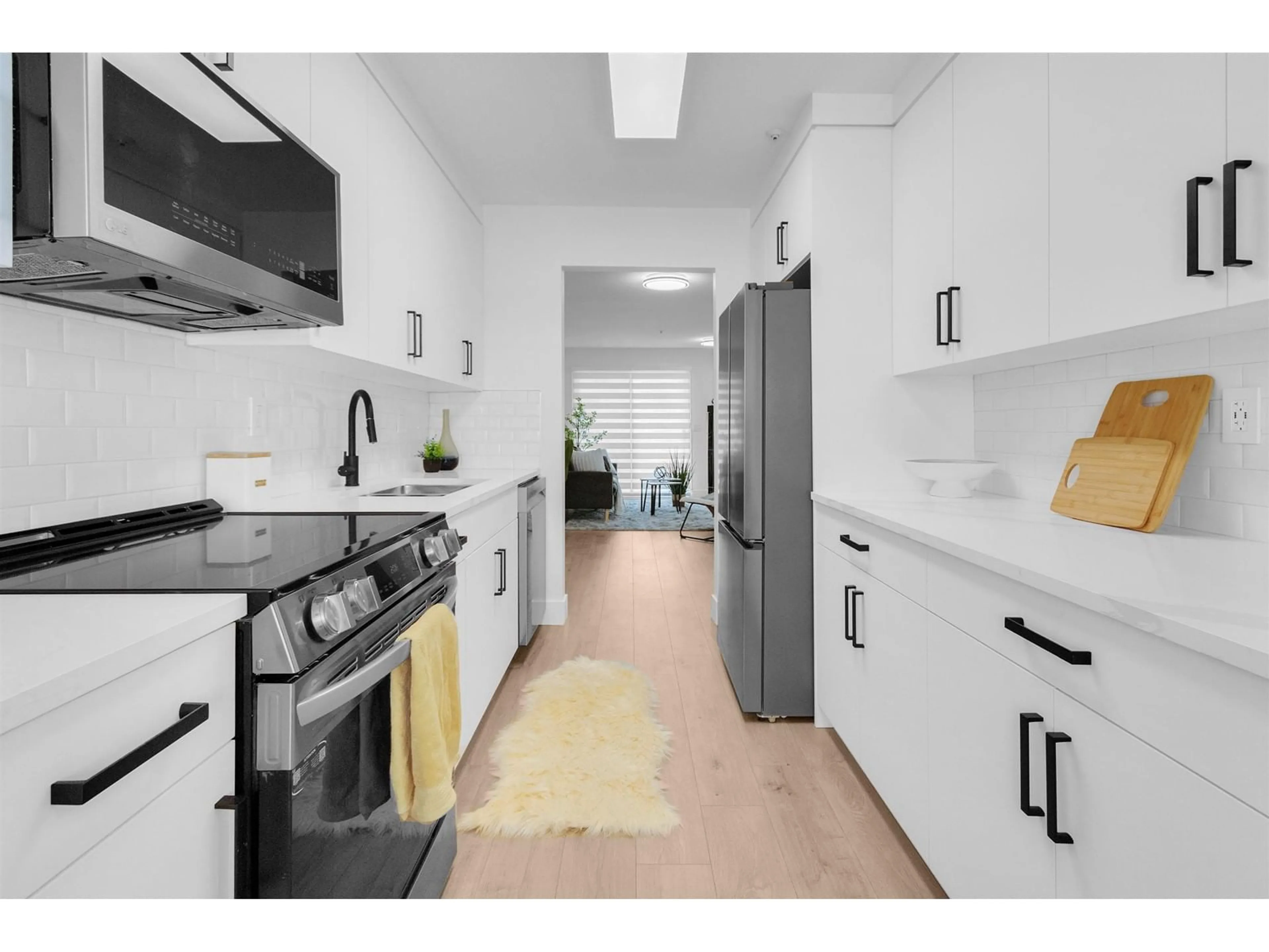 Kitchen with laundary machines, wood floors for 202 20240 54A AVENUE, Langley British Columbia V3A3W7