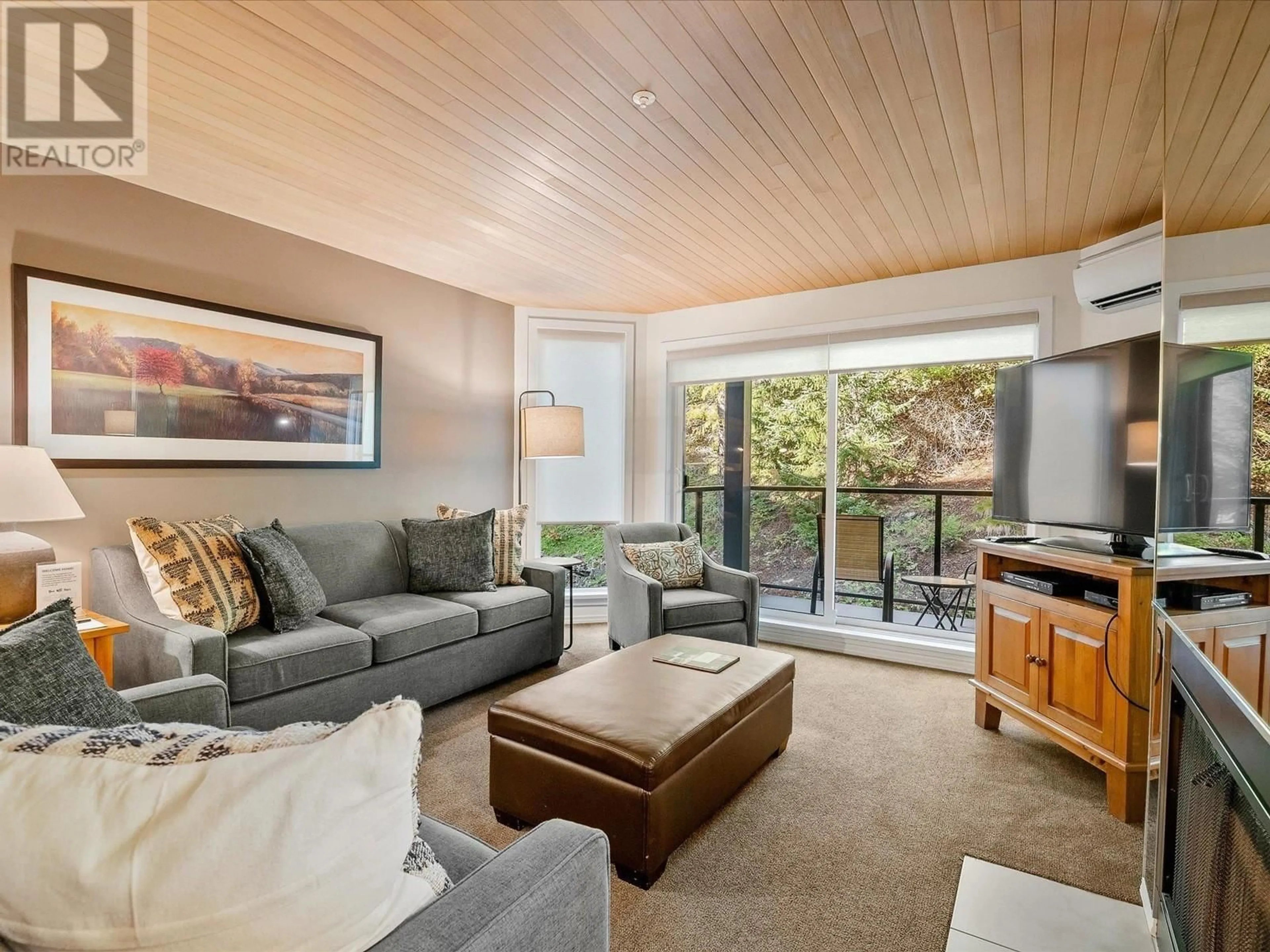 Living room with furniture, wood/laminate floor for 204 - 3217 BLUEBERRY DRIVE, Whistler British Columbia V8E0B8