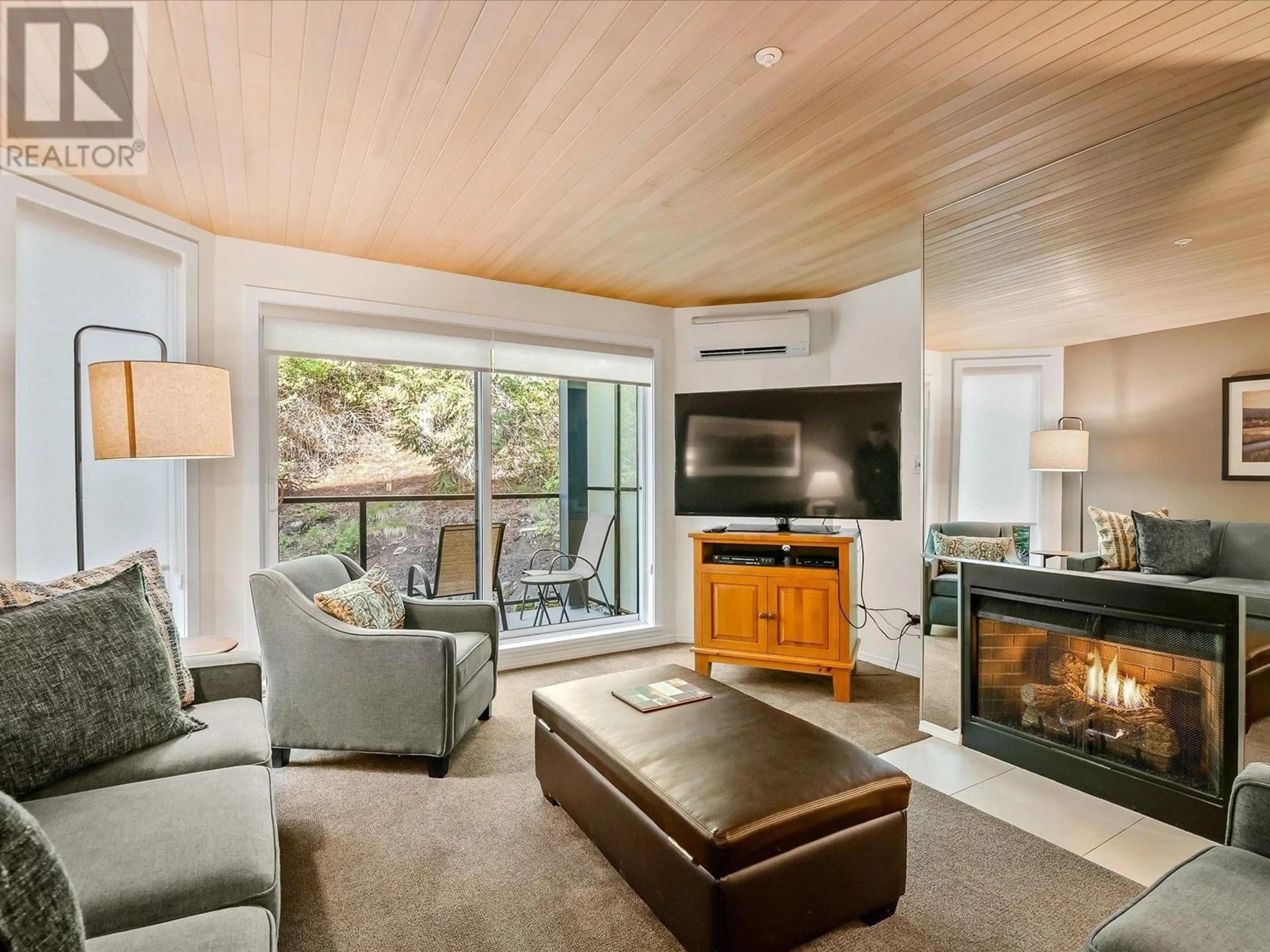 Living room with furniture, wood/laminate floor for 204 - 3217 BLUEBERRY DRIVE, Whistler British Columbia V8E0B8