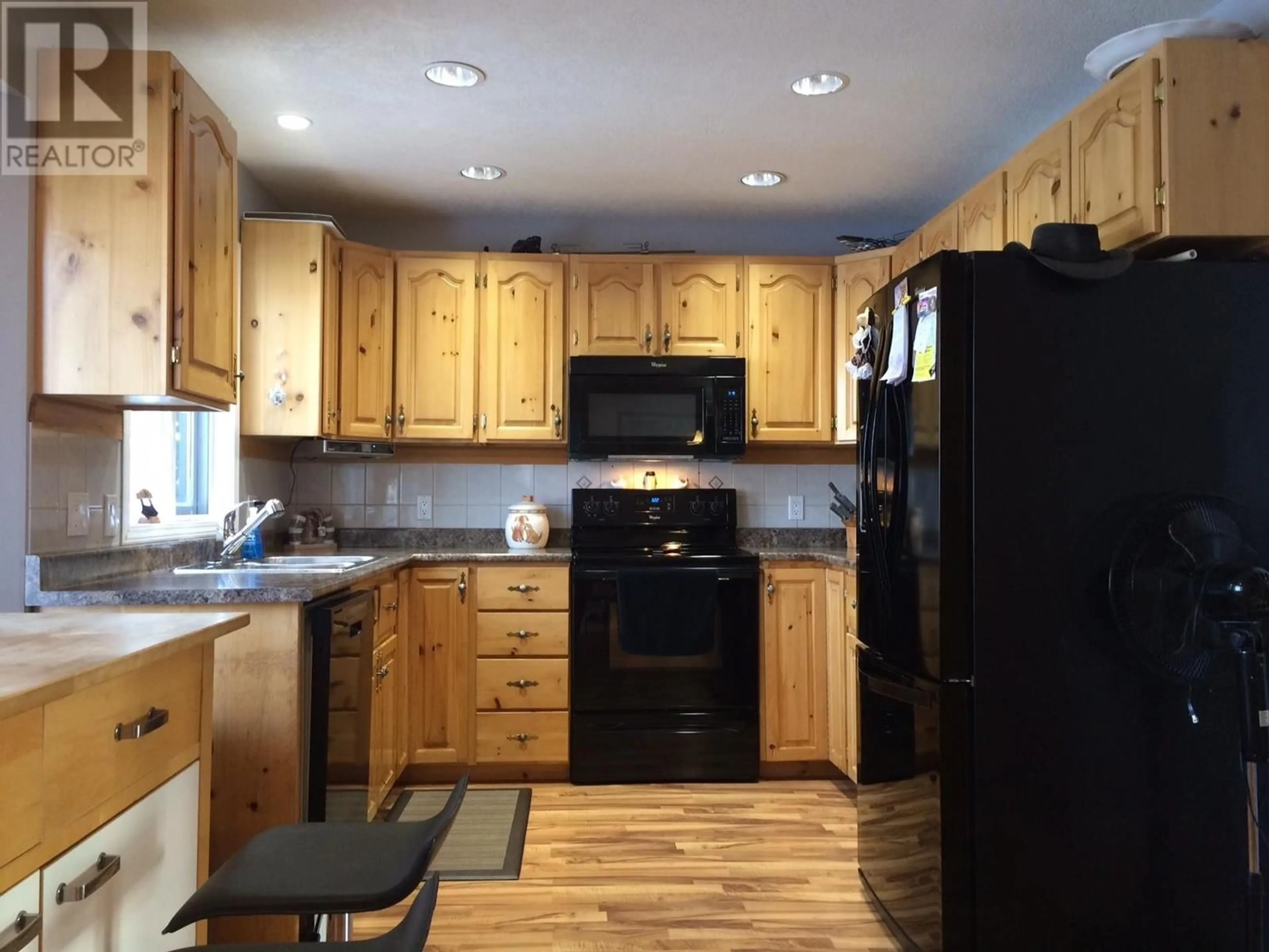 Standard kitchen, wood floors, cottage for 5520 TUCHODI AVENUE, Fort Nelson British Columbia V0C1R0