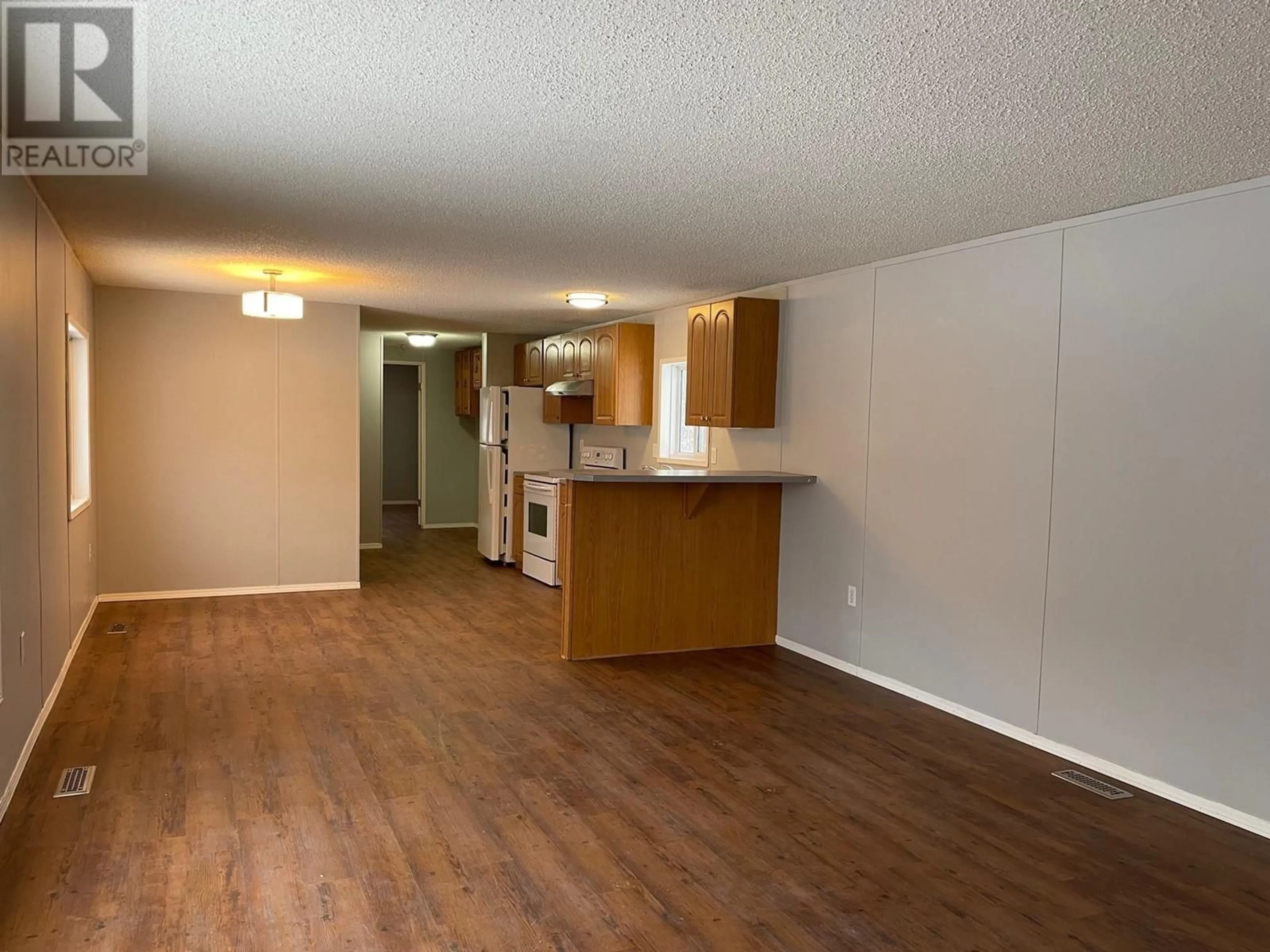 A pic of a room, wood floors for 27 5701 AIRPORT DRIVE, Fort Nelson British Columbia V0C1R0