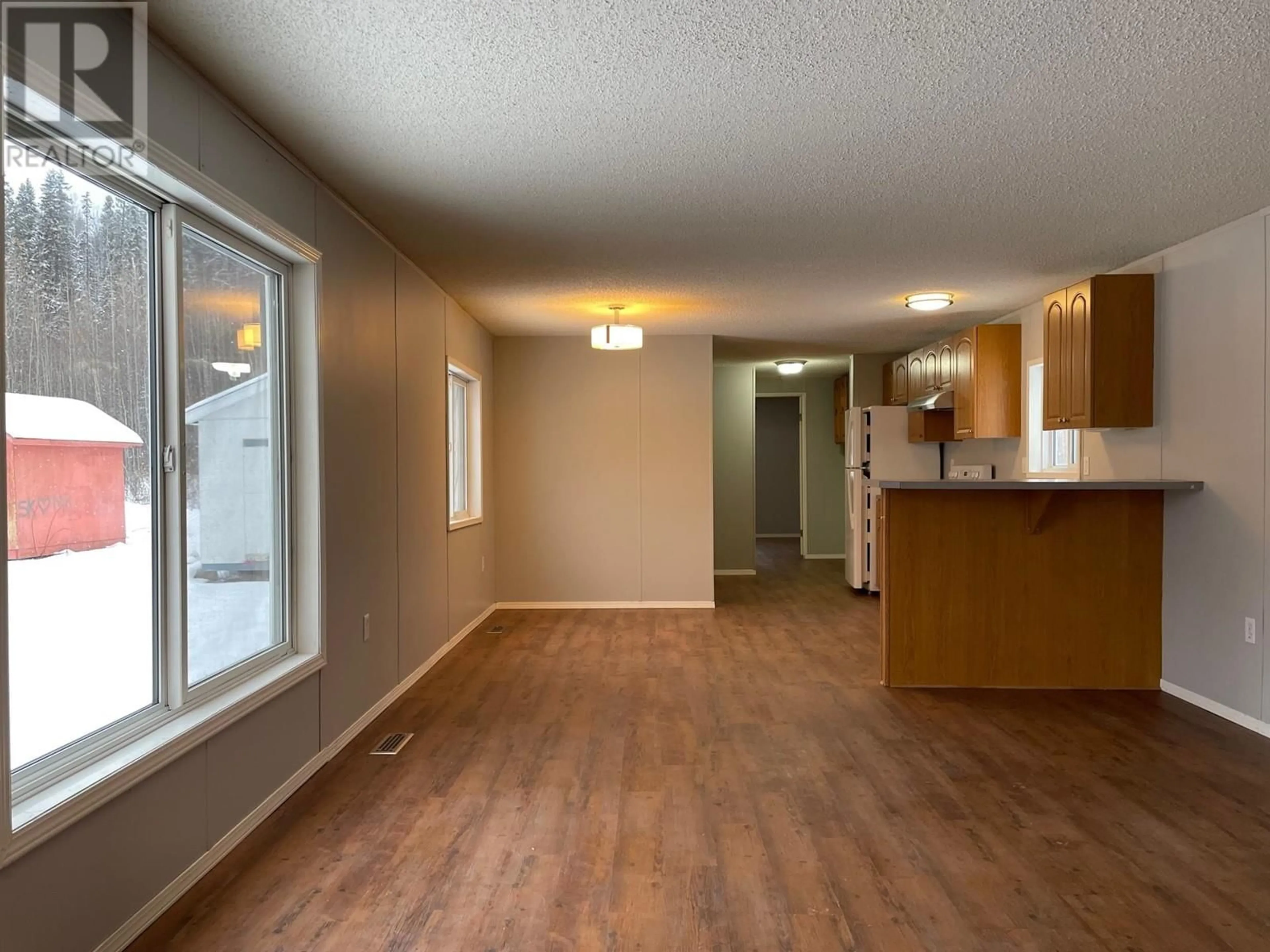 A pic of a room, wood floors for 27 5701 AIRPORT DRIVE, Fort Nelson British Columbia V0C1R0