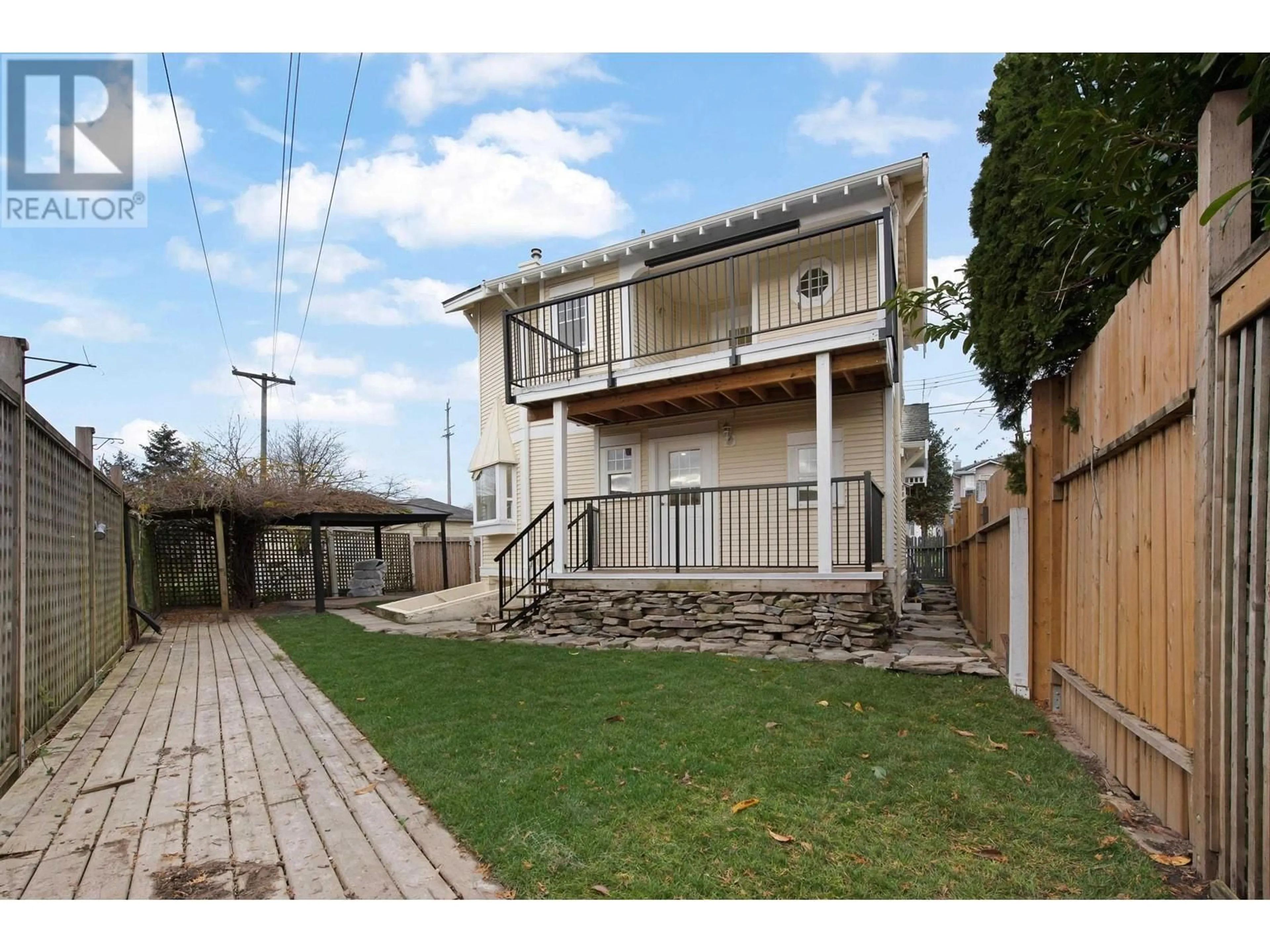 Frontside or backside of a home, the fenced backyard for 2208 HAMILTON STREET, New Westminster British Columbia V3M2R1