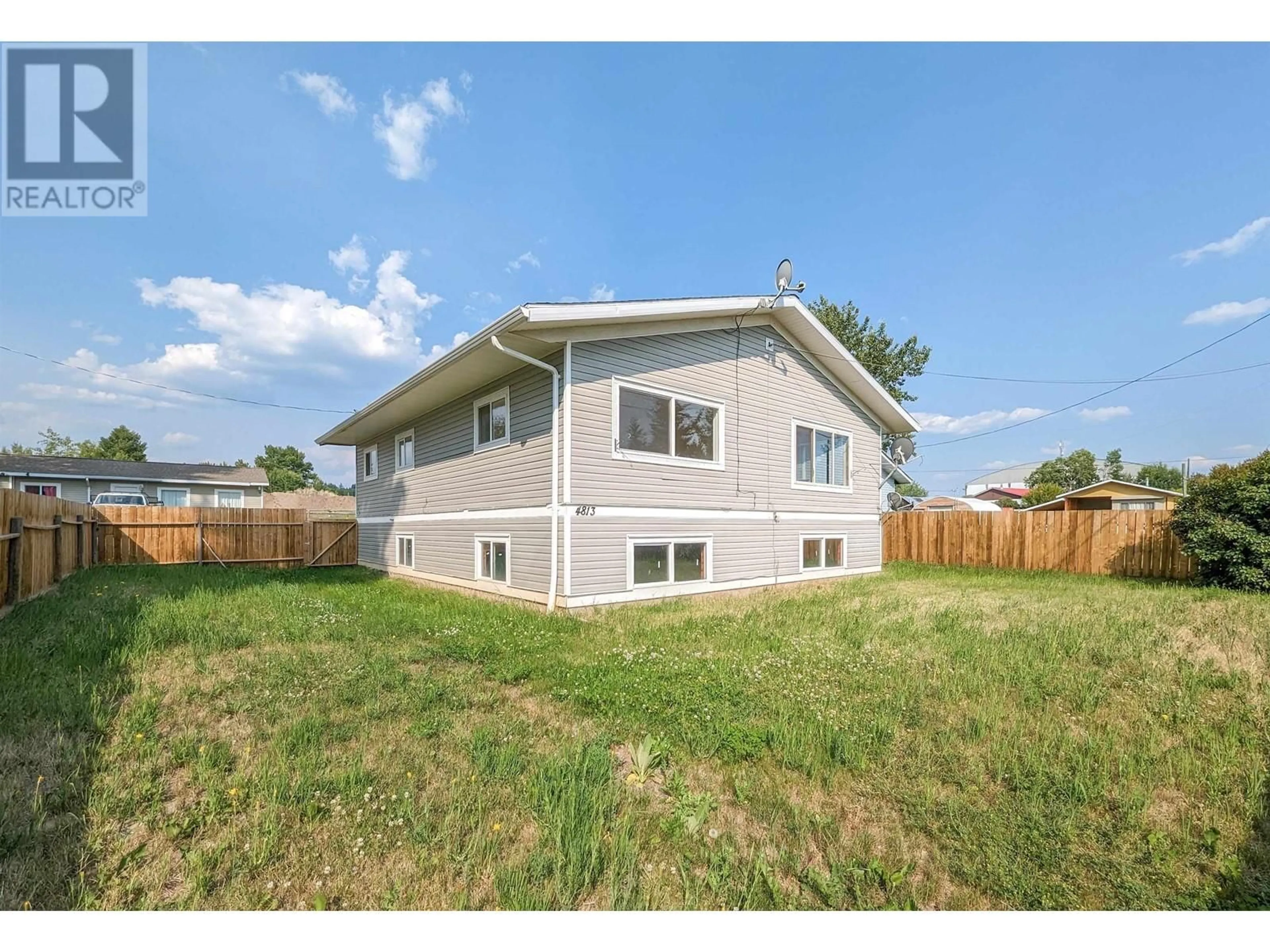 Frontside or backside of a home, the fenced backyard for 4813 EAGLE AVENUE, Lac La Hache British Columbia V0K1T0