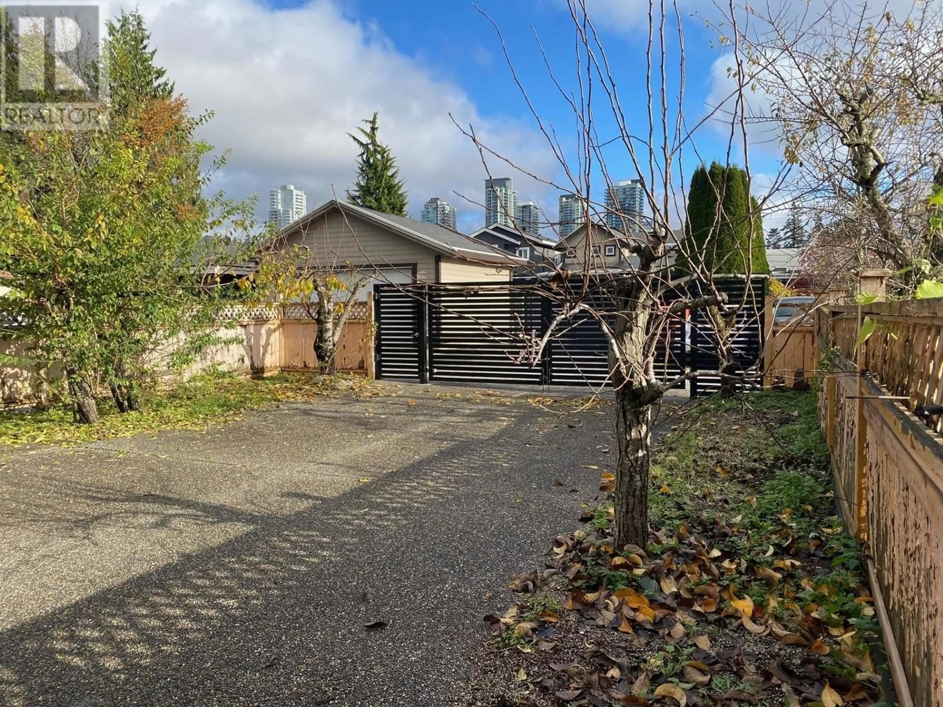 Frontside or backside of a home, the fenced backyard for 6918 DOW AVENUE, Burnaby British Columbia V5J3W9