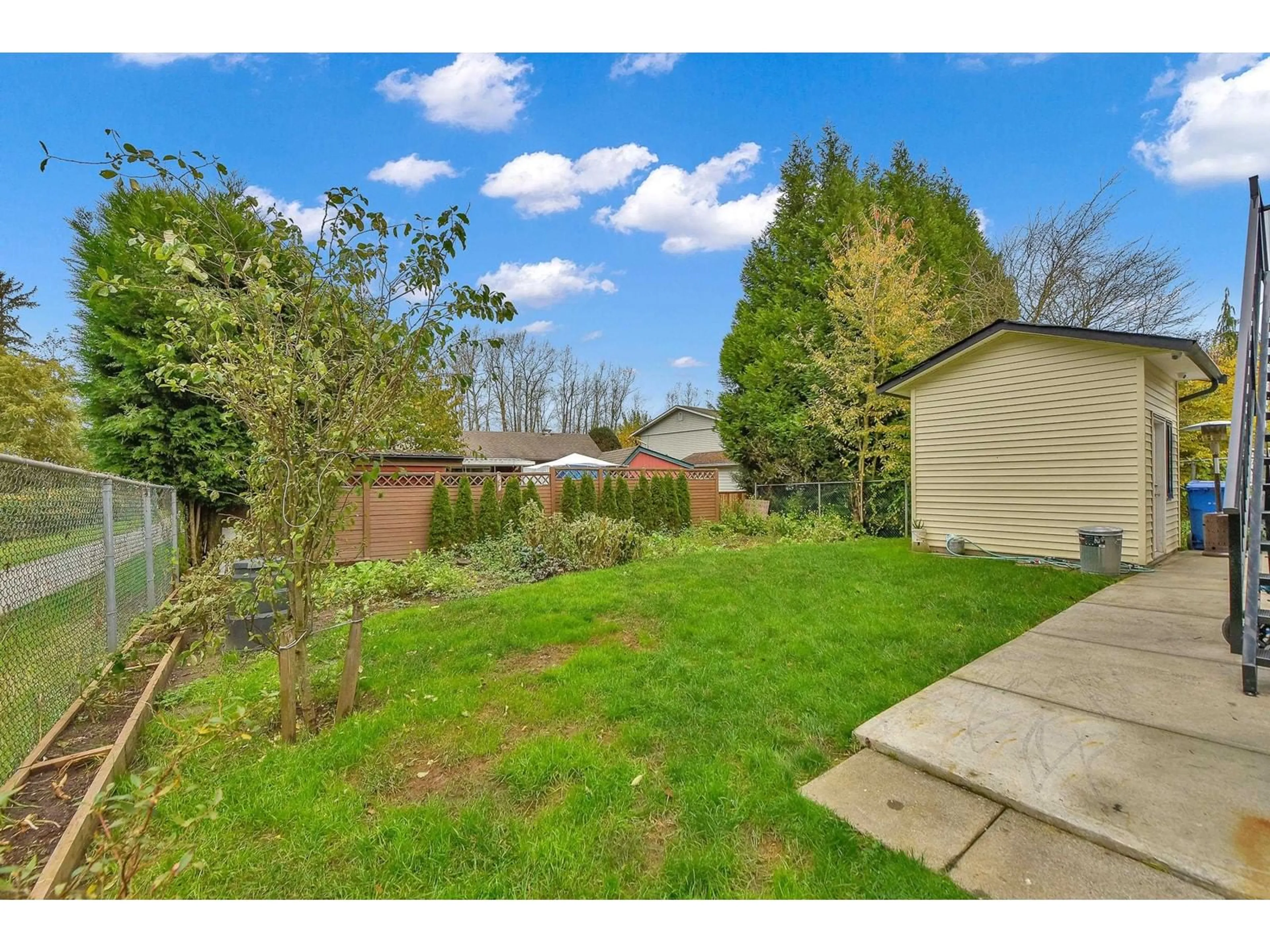 Frontside or backside of a home, the fenced backyard for 20703 51B AVENUE, Langley British Columbia V3A7T5