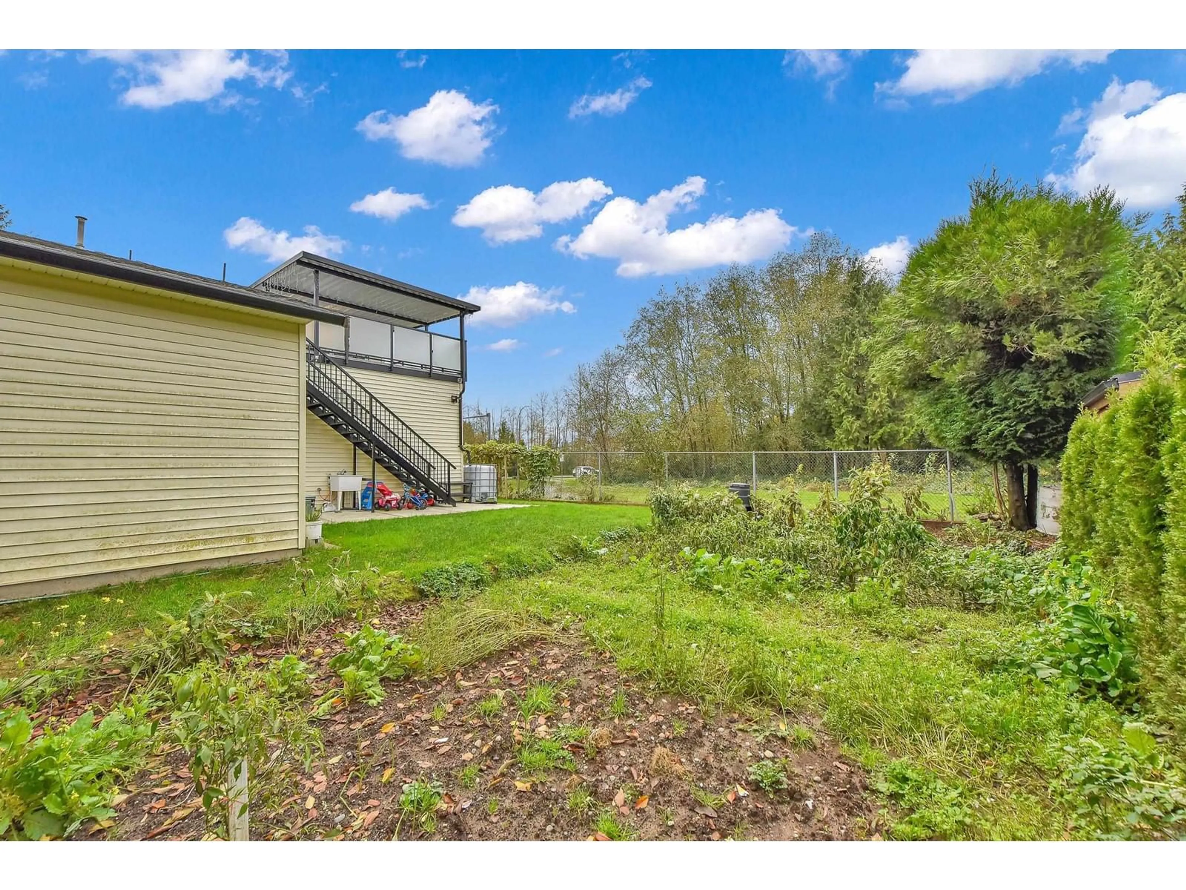 A pic from exterior of the house or condo, the fenced backyard for 20703 51B AVENUE, Langley British Columbia V3A7T5