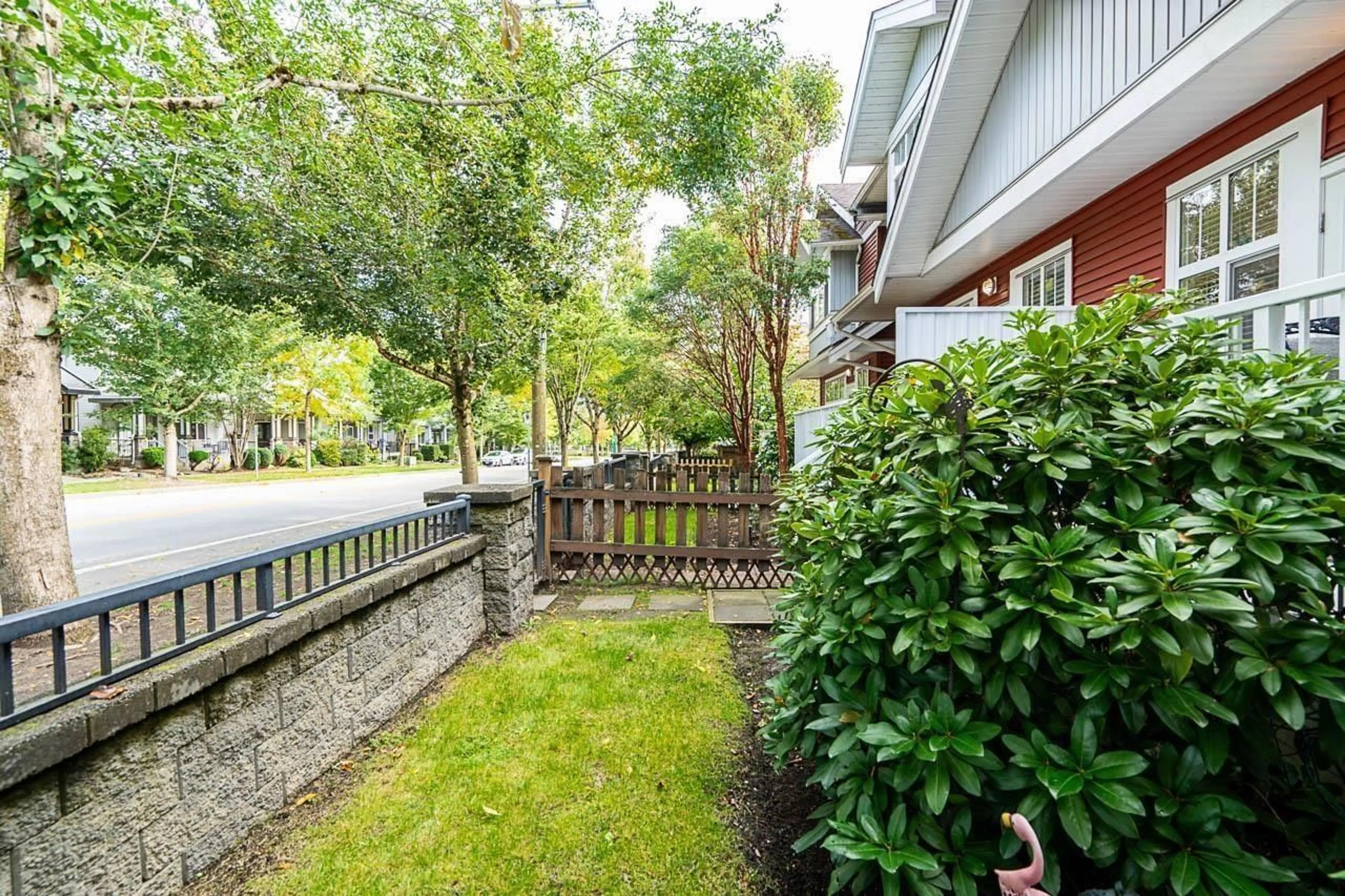 A pic from exterior of the house or condo, the fenced backyard for 12 6785 193 STREET, Surrey British Columbia V4N0Z4