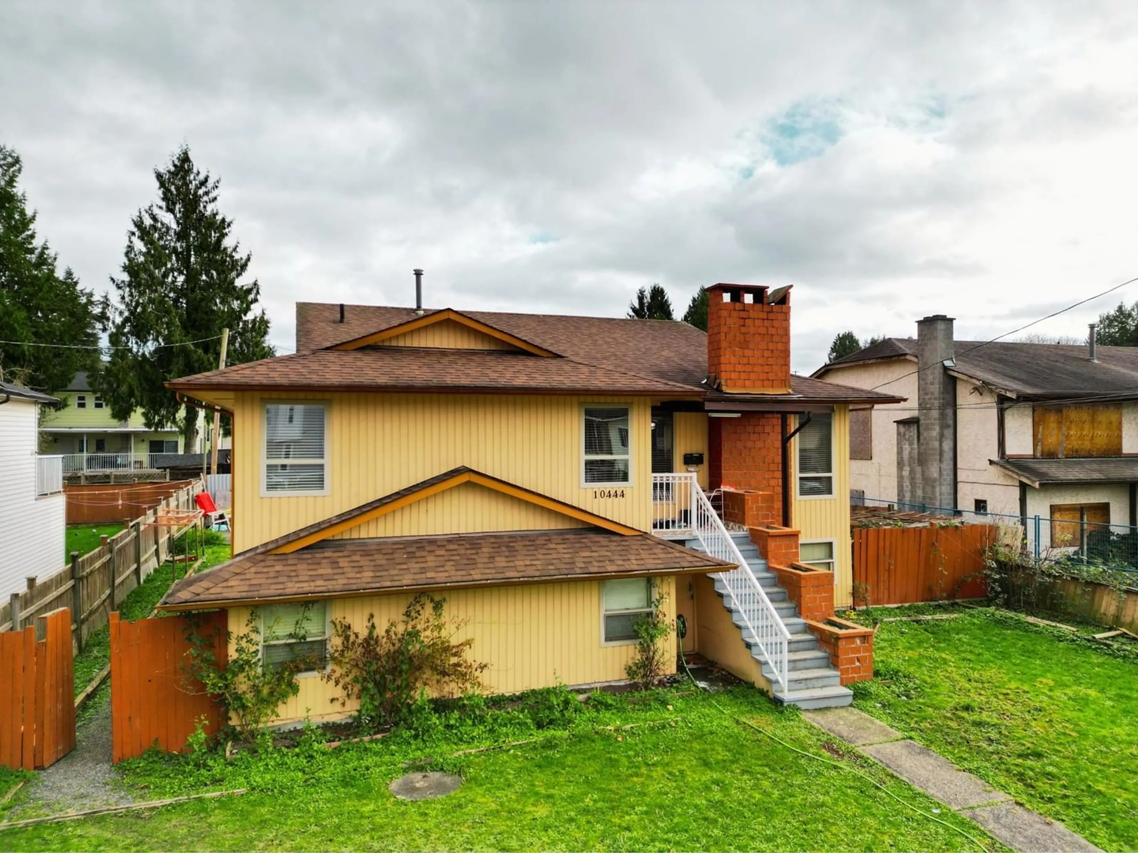 Frontside or backside of a home, the fenced backyard for 10444 128 STREET, Surrey British Columbia V3T5J1