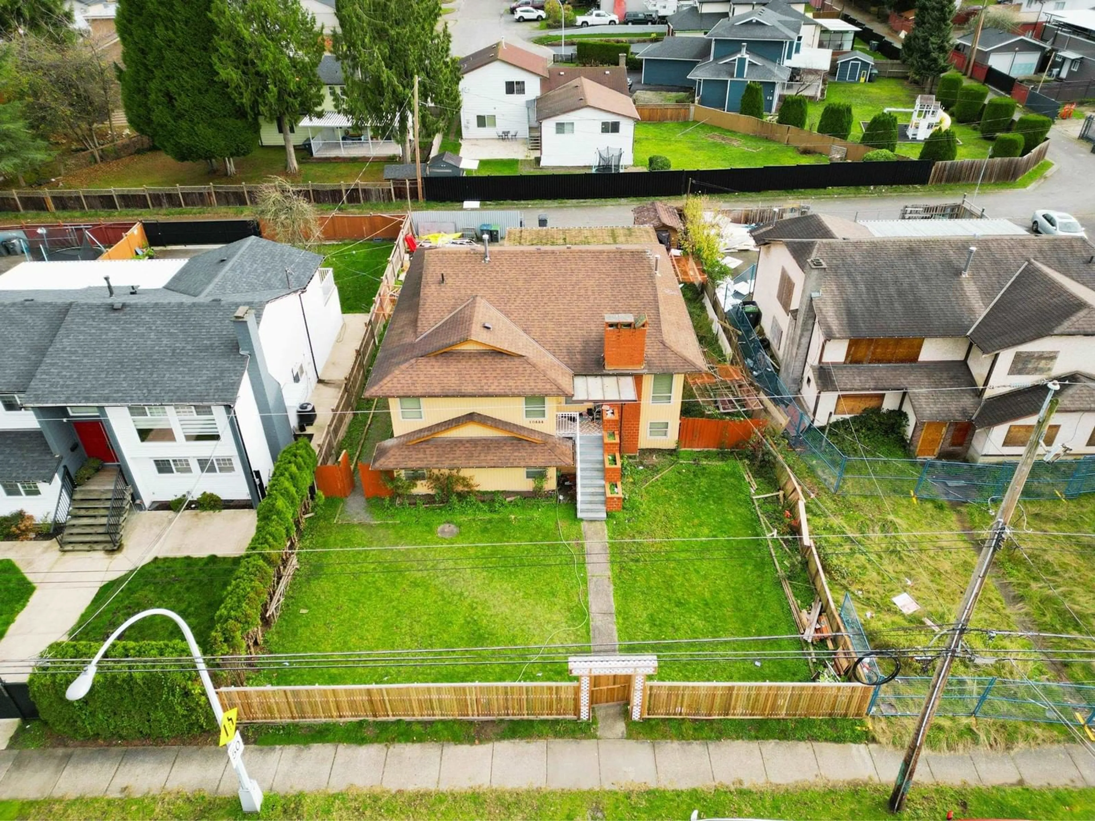 Frontside or backside of a home, the fenced backyard for 10444 128 STREET, Surrey British Columbia V3T5J1