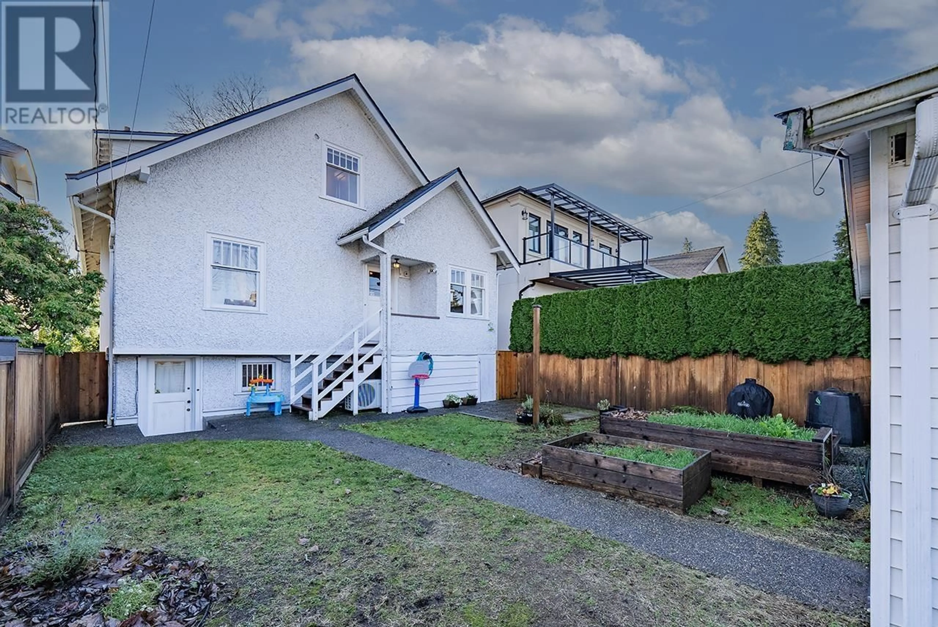 Frontside or backside of a home, the fenced backyard for 3873 22ND AVE W AVENUE, Vancouver British Columbia V6S1J8