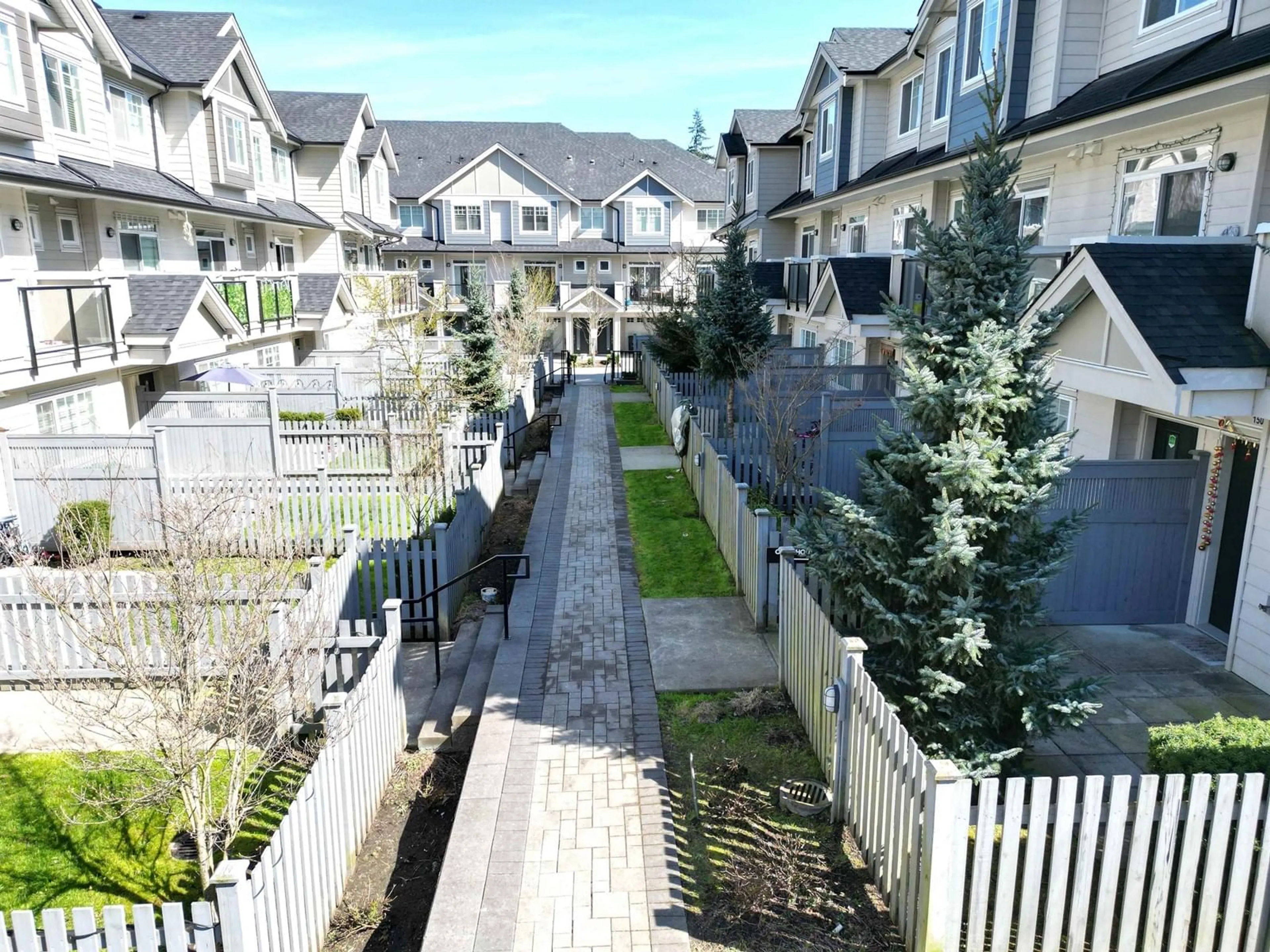 A pic from exterior of the house or condo, the fenced backyard for 150 13898 64 AVENUE, Surrey British Columbia V3W1L6