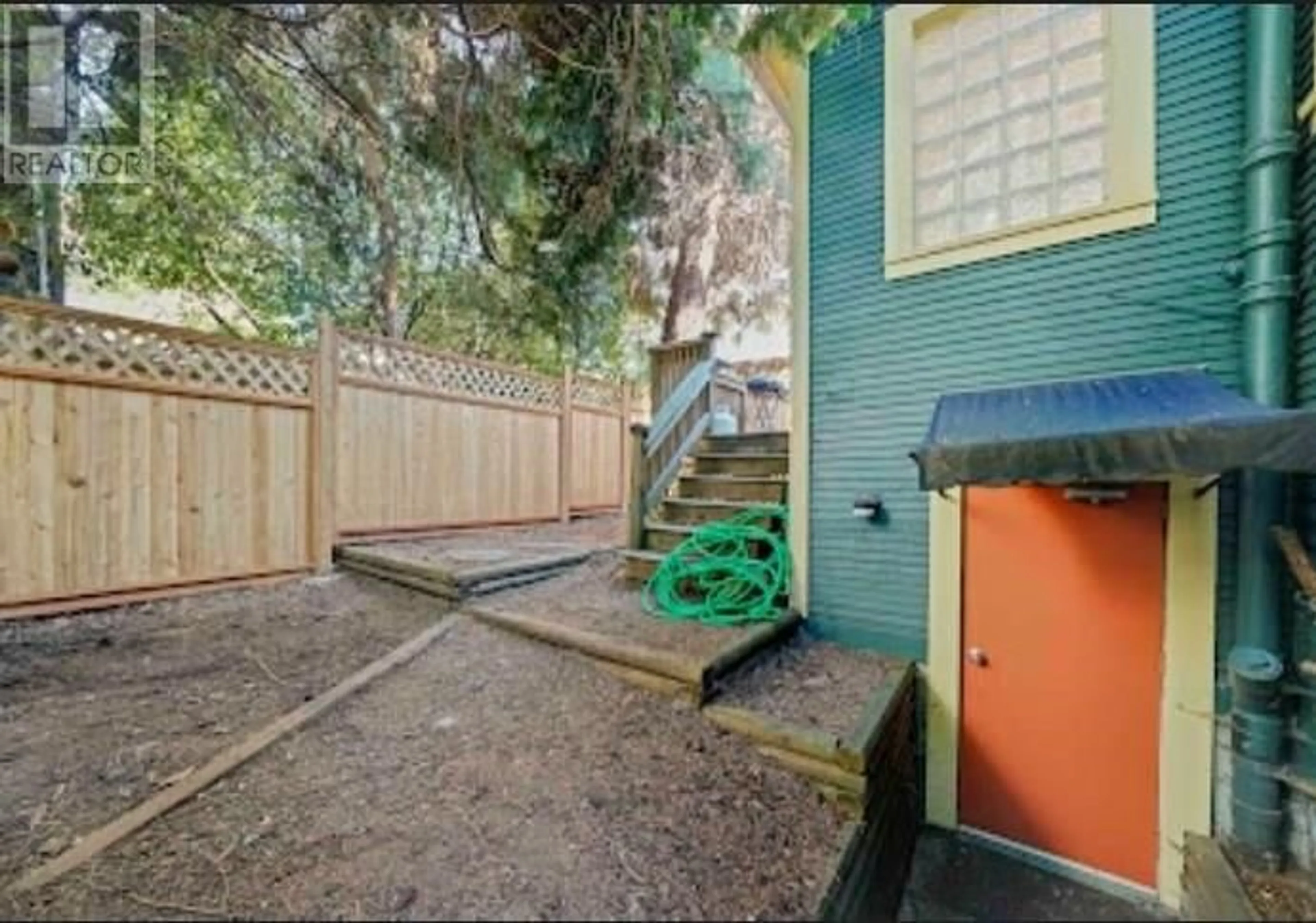 A pic from exterior of the house or condo, the fenced backyard for 1620 MCLEAN DRIVE, Vancouver British Columbia V5L3P3