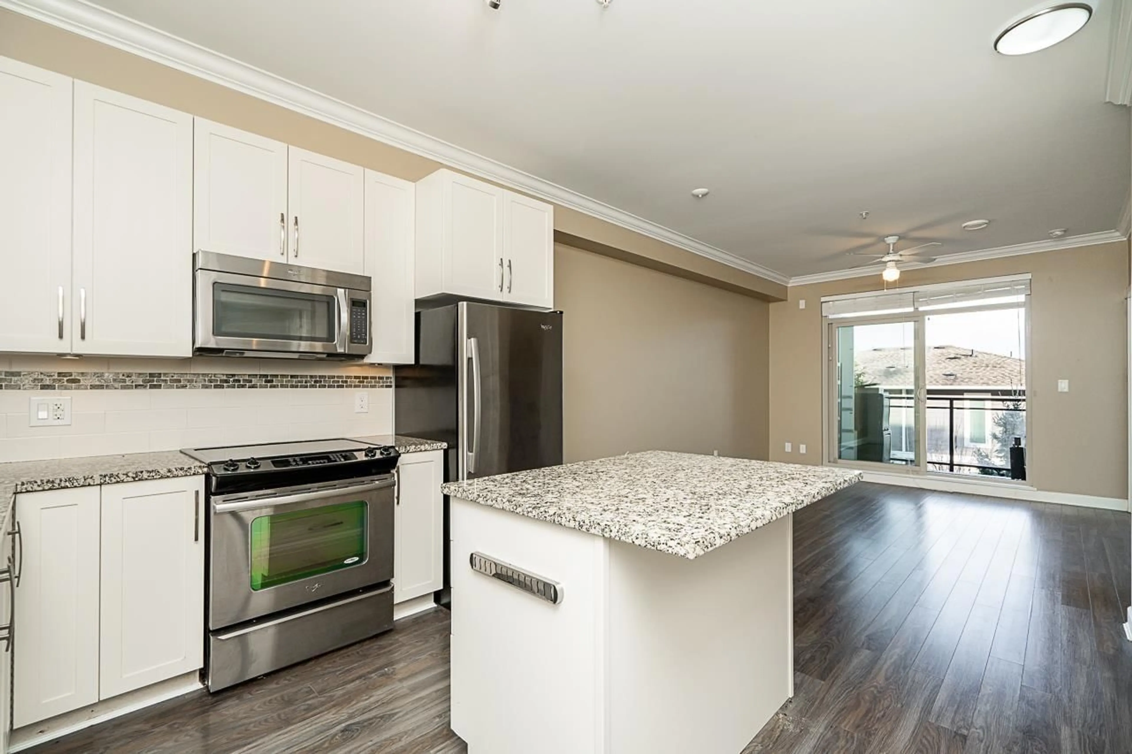 Open concept kitchen, wood/laminate floor for 308 20861 83 AVENUE, Langley British Columbia V2Y0M8