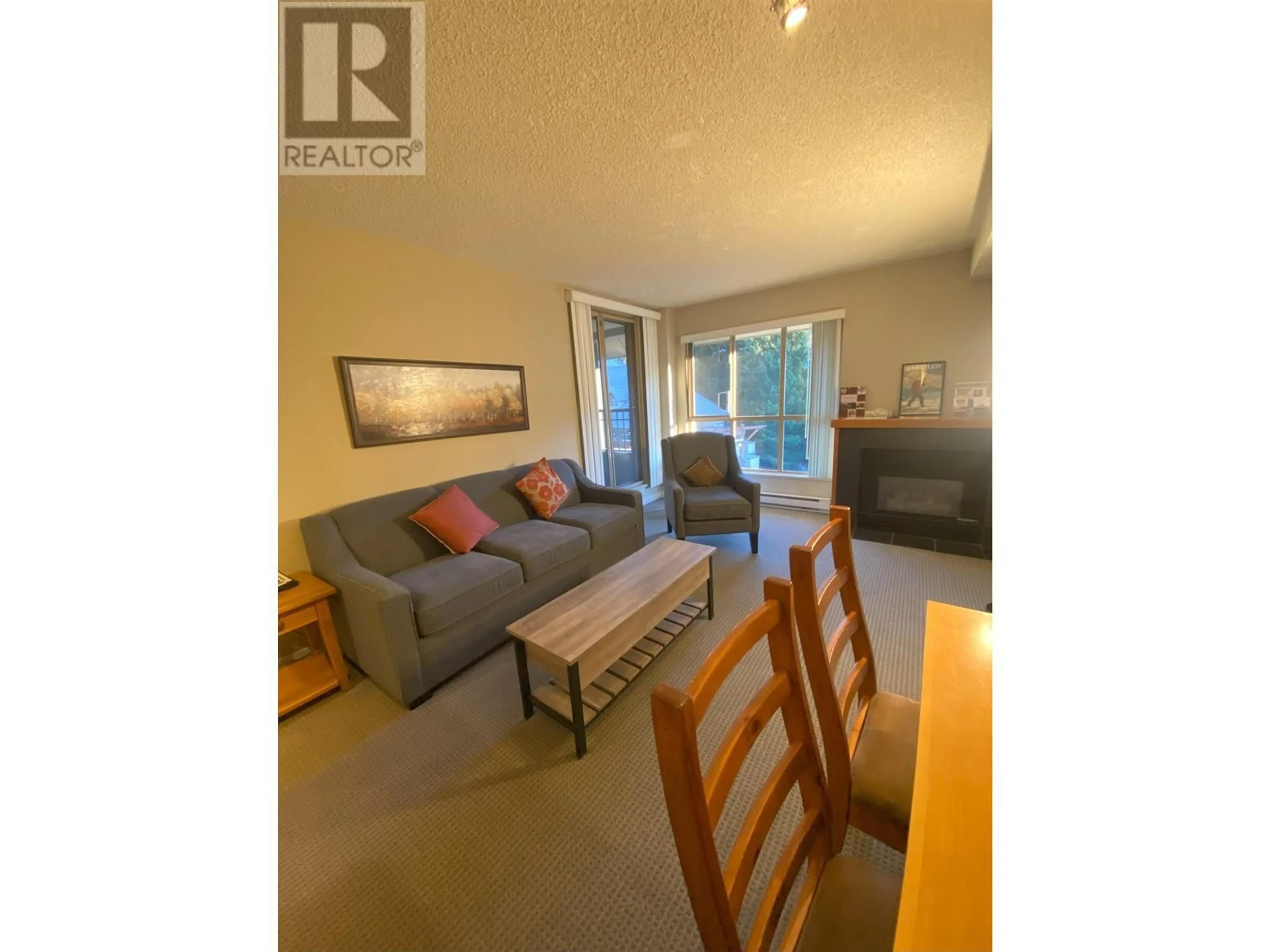 Living room with furniture, wood/laminate floor for 402 4295 BLACKCOMB WAY, Whistler British Columbia V8E0X2