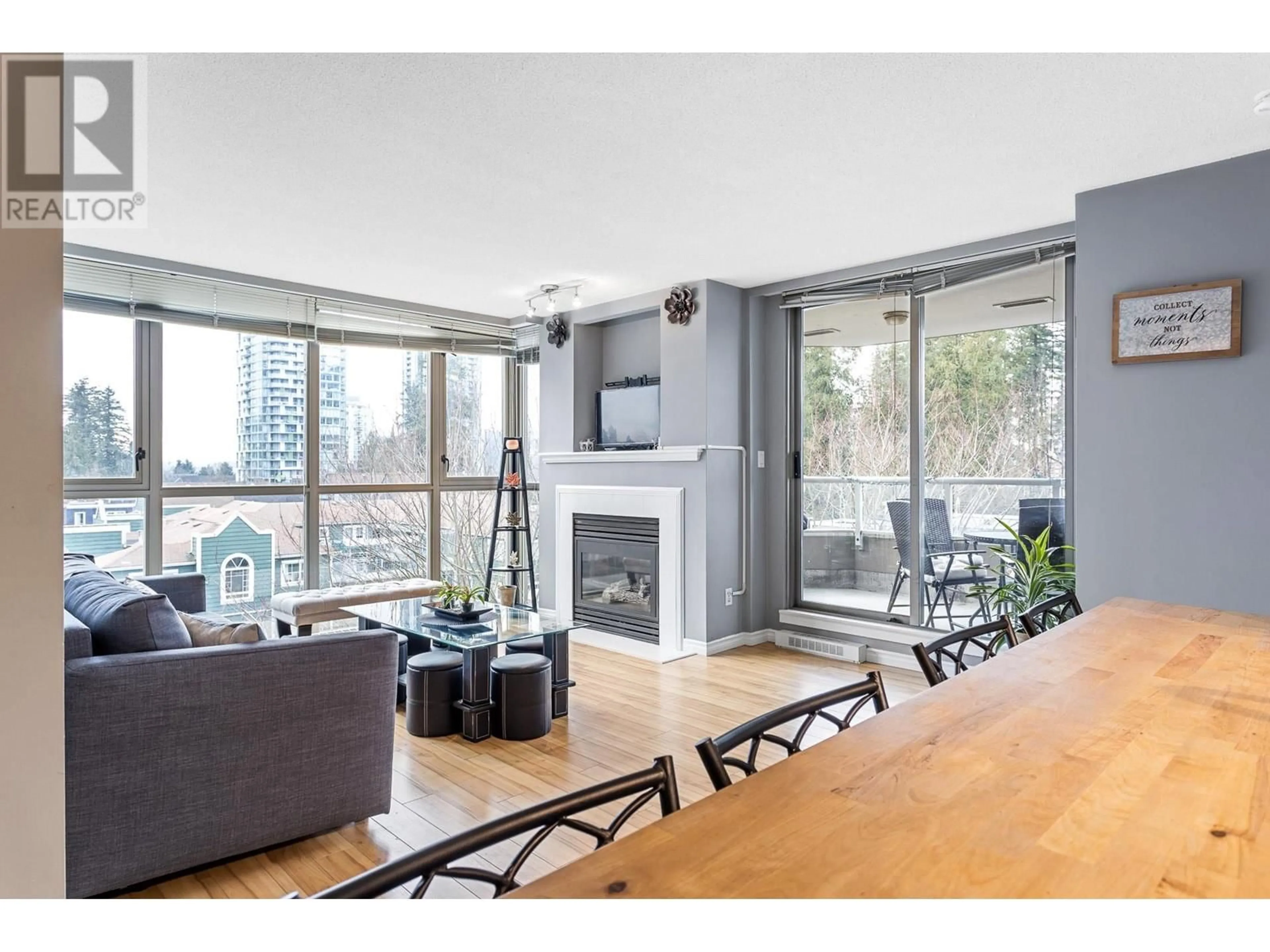 Living room with furniture, wood/laminate floor for 501 3070 GUILDFORD WAY, Coquitlam British Columbia V3B7R8